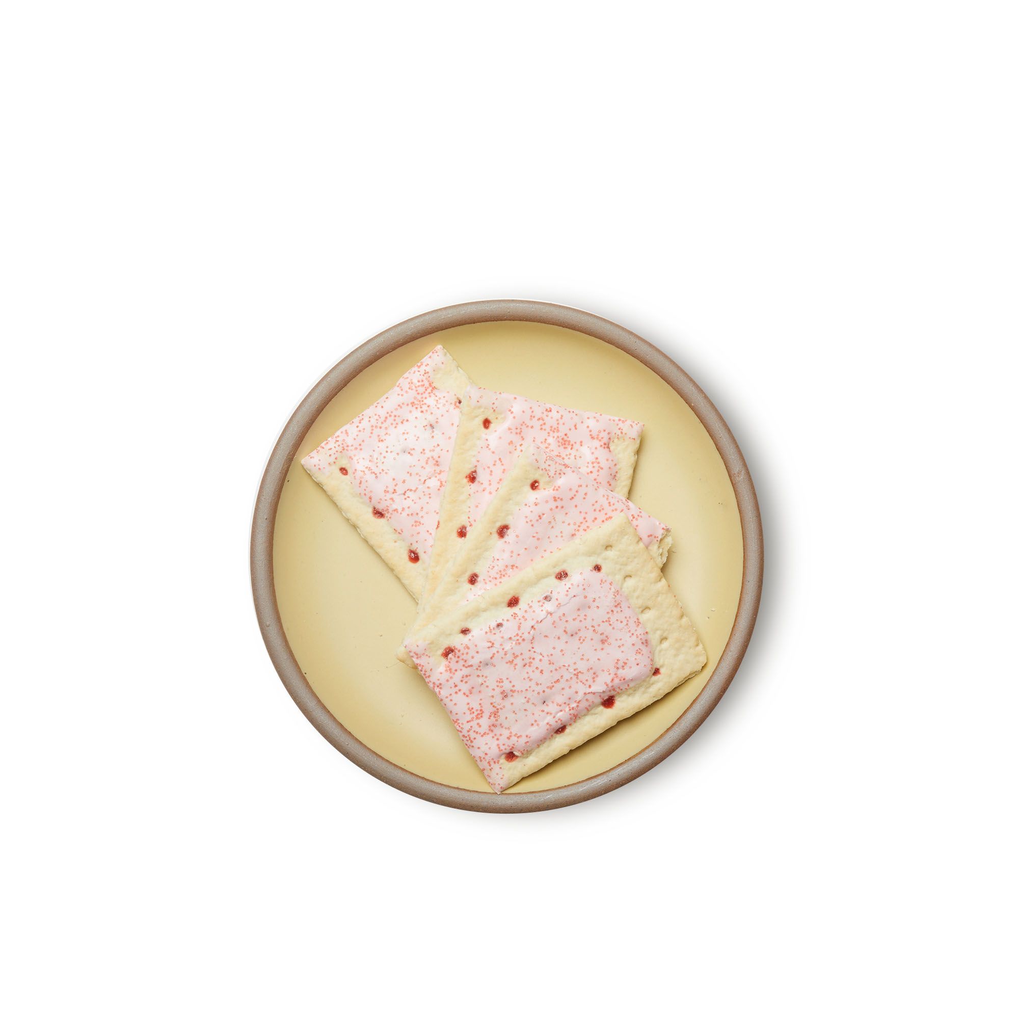 Pop-tarts on a medium sized ceramic plate in a light butter yellow color featuring iron speckles and an unglazed rim.