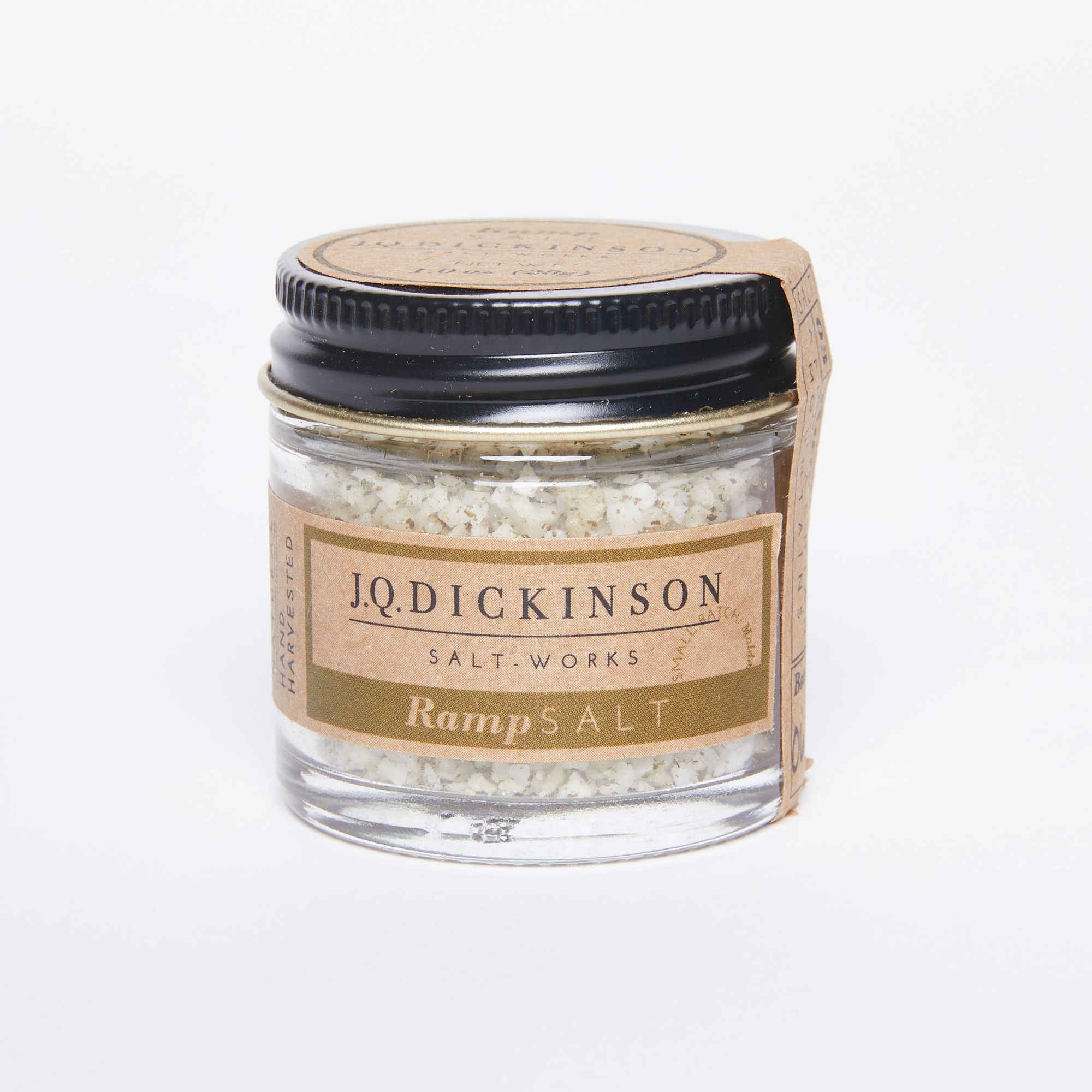 Round glass jar full of large salt crystals with a black screw lid and a natural color label that reads "JQ Dickinson Salt Works Ramp Salt"