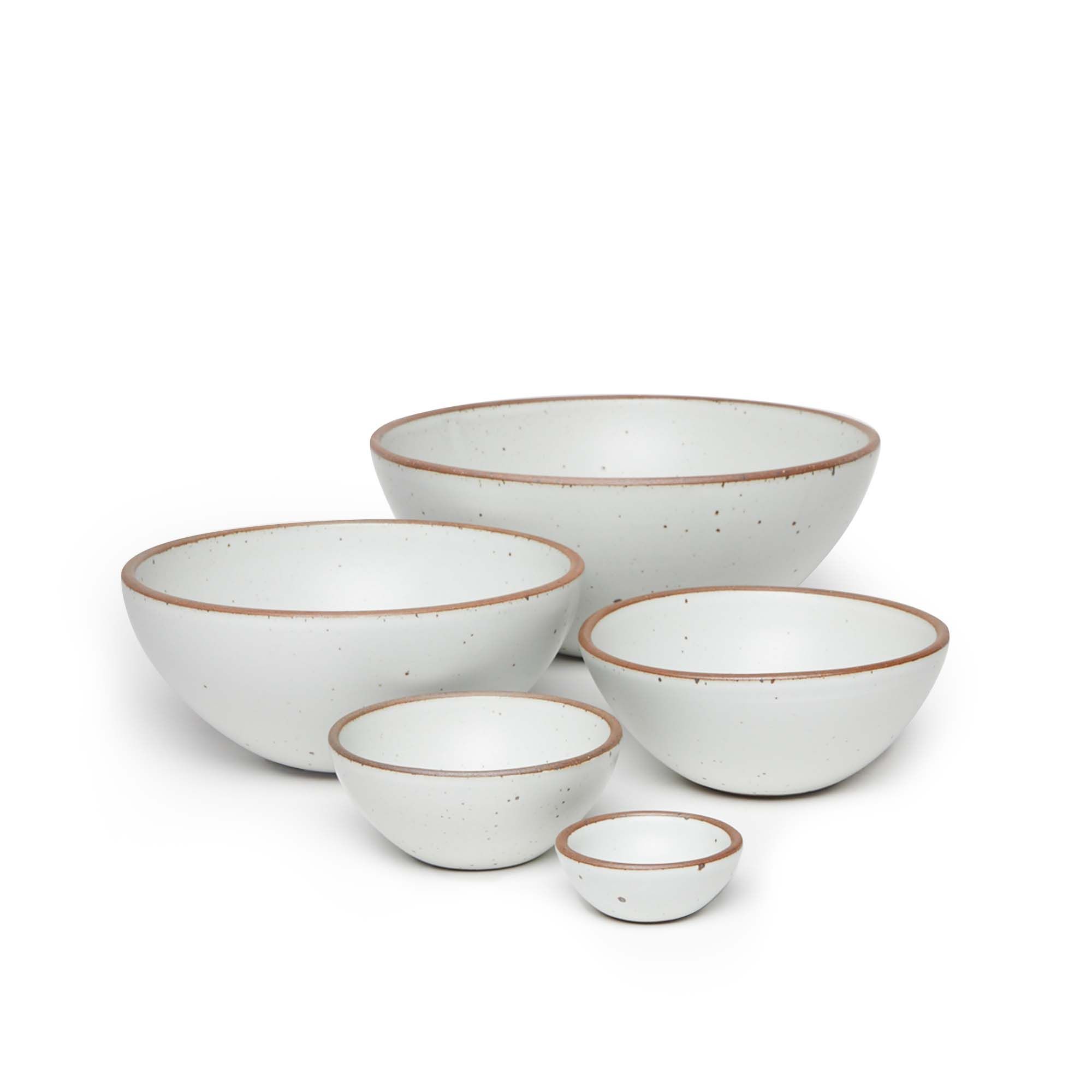 A bitty bowl, ice cream bowl, soup bowl, popcorn bowl, and mixing bowl paired together in a cool white color featuring iron speckles.