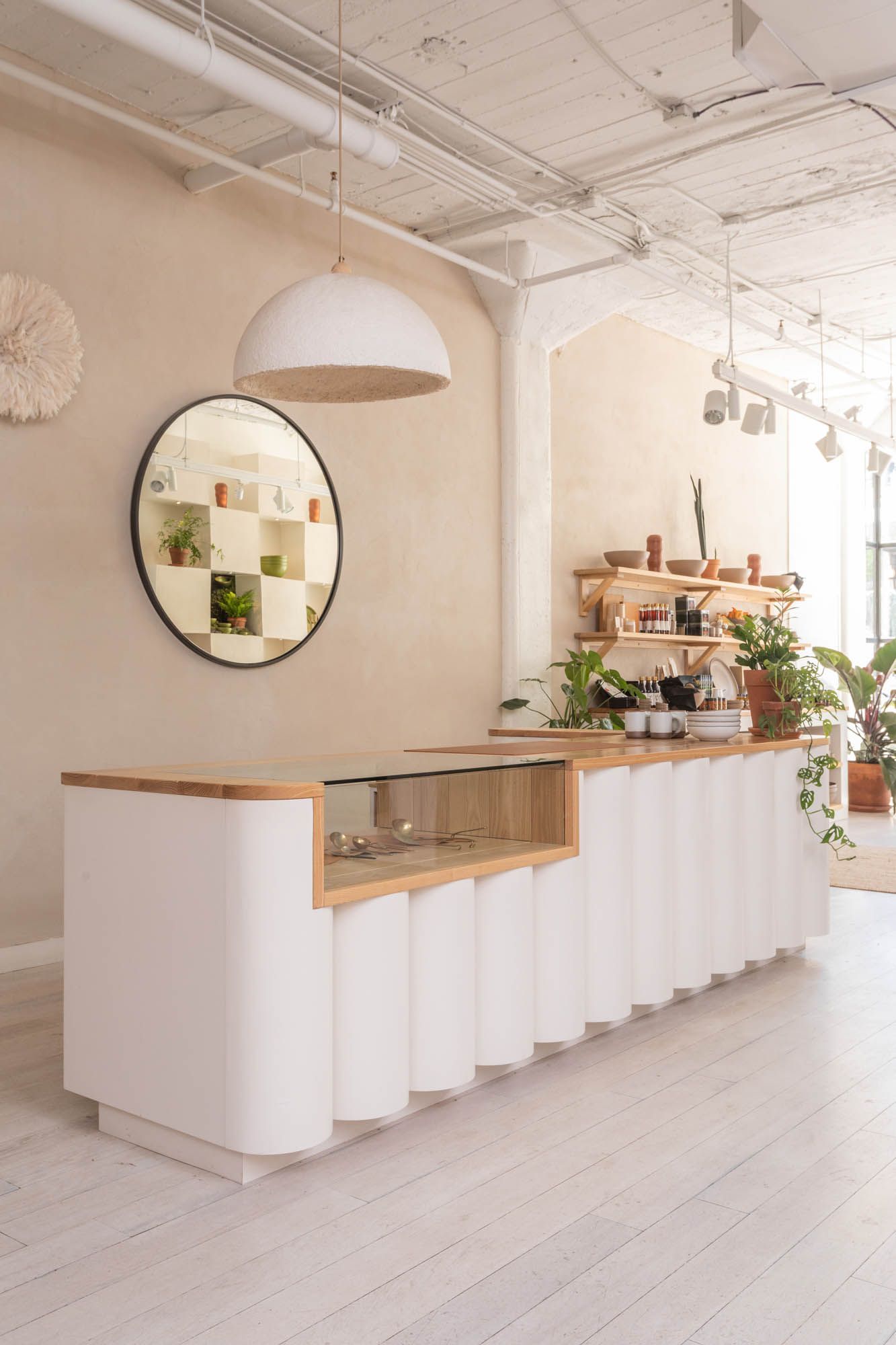 The East Fork Atlanta Cash Wrap with a long fluted white table and wood countertop