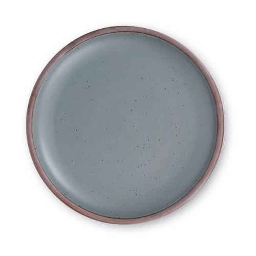 A large ceramic platter in a cool terracotta color featuring iron speckles and an unglazed rim.