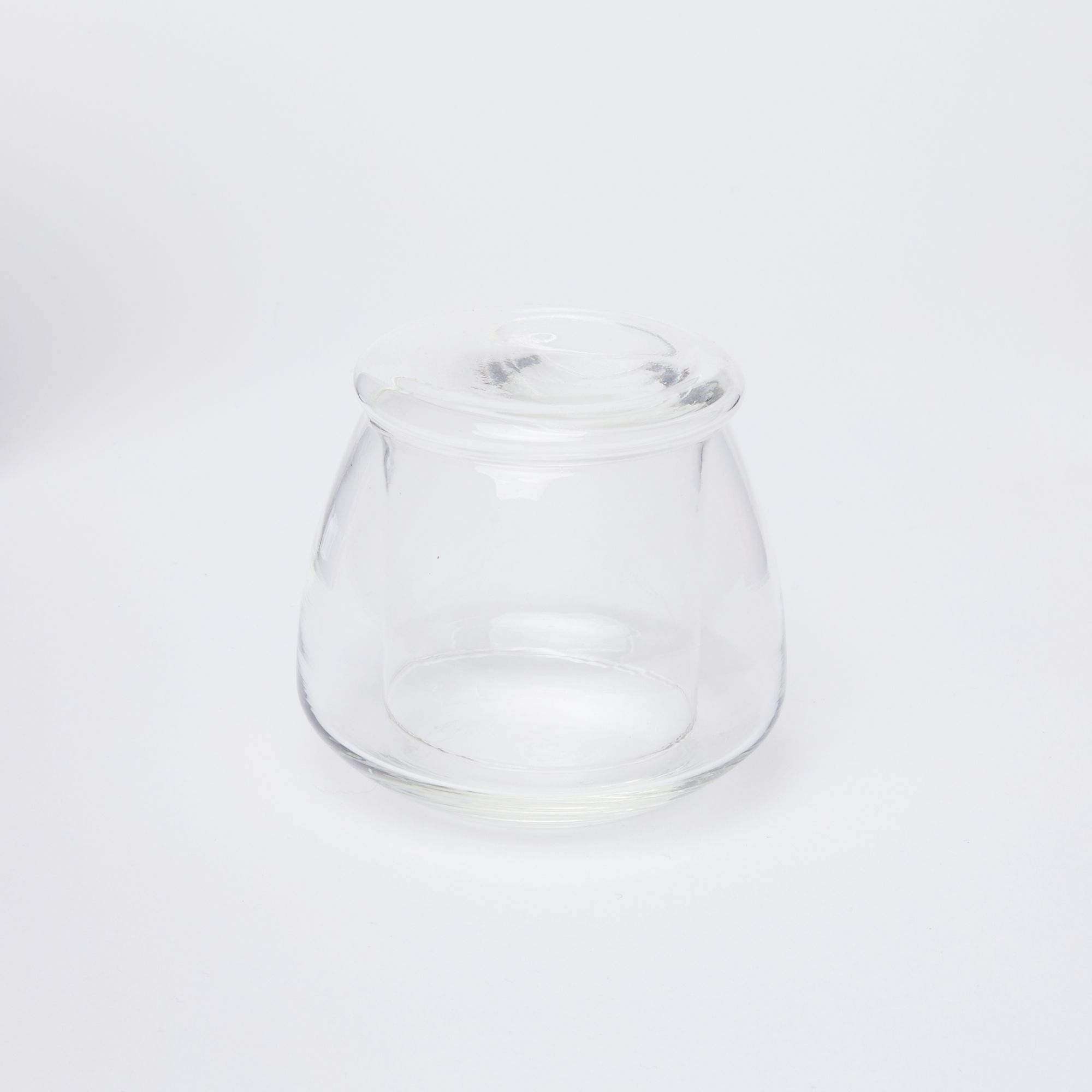 Clear glass butter keeper on white background