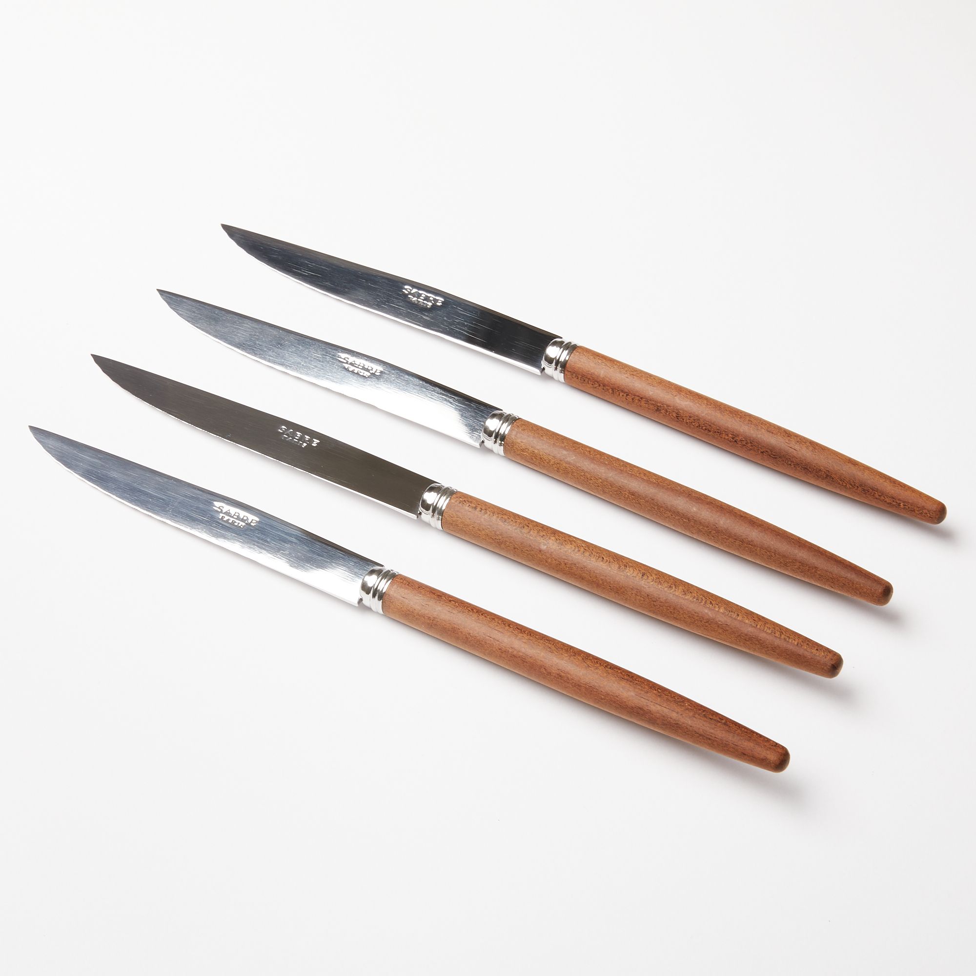 Four steak knives with steel blades and simple wood handles