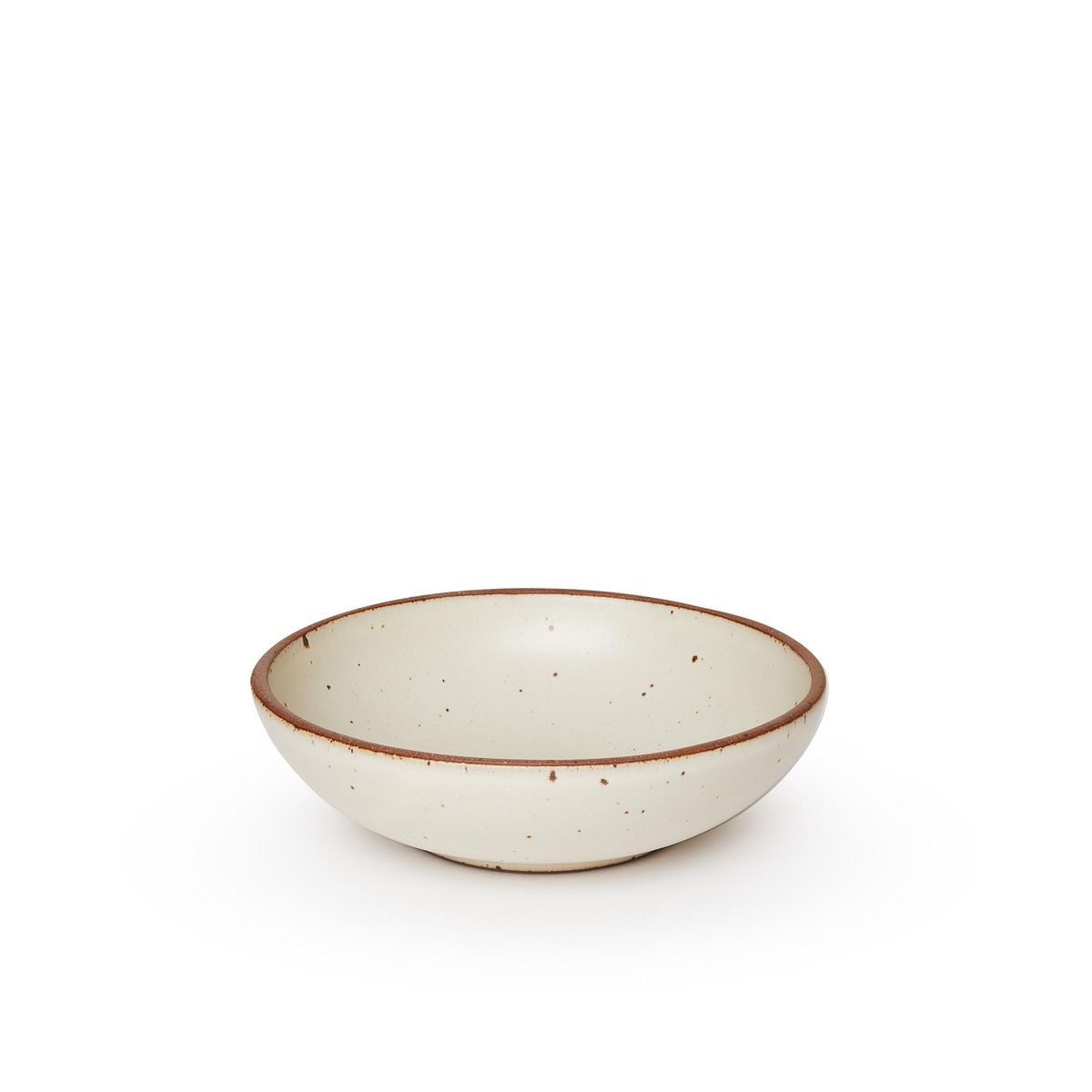 A dinner-sized shallow ceramic bowl in a warm, tan-toned, off-white color featuring iron speckles and an unglazed rim