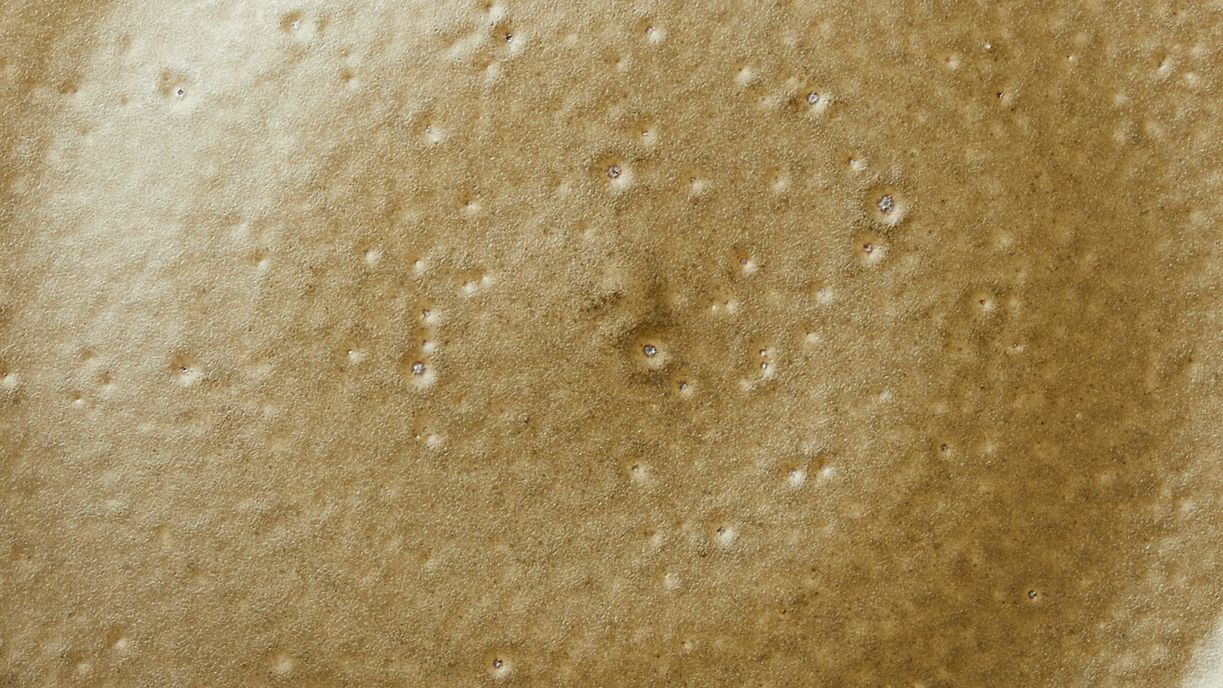 A close up of Ash Glaze, a neutral green with specks of texture