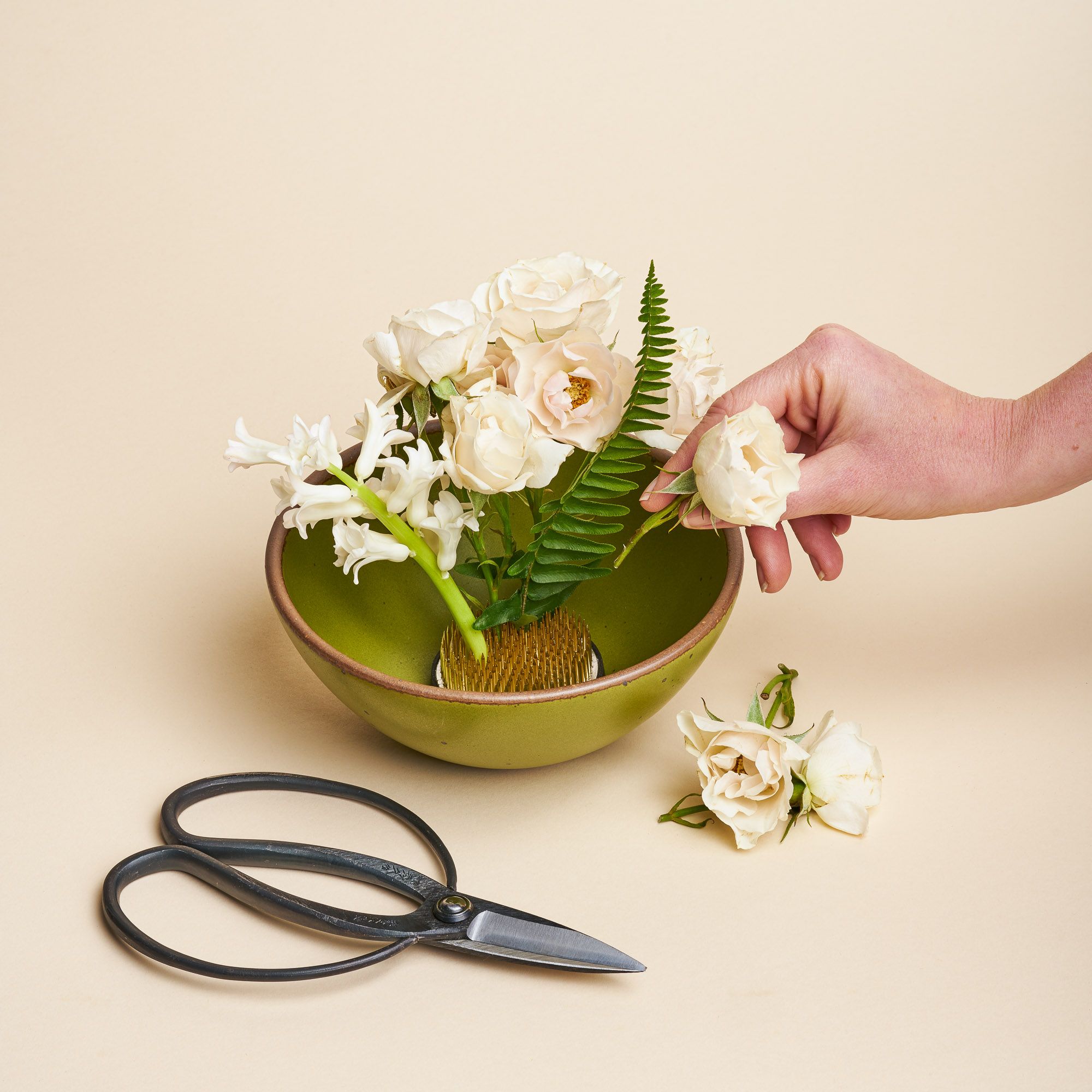 A set that comes with gardening shears, a green East Fork bowl and a "Flower Flog," a small circular dish with spikes used to construct floral arrangements and keep flowers in place. Flower frogs sit inside the floral container in the water and are traditionally known for their use in ikebana, the Japanese art of floral design.