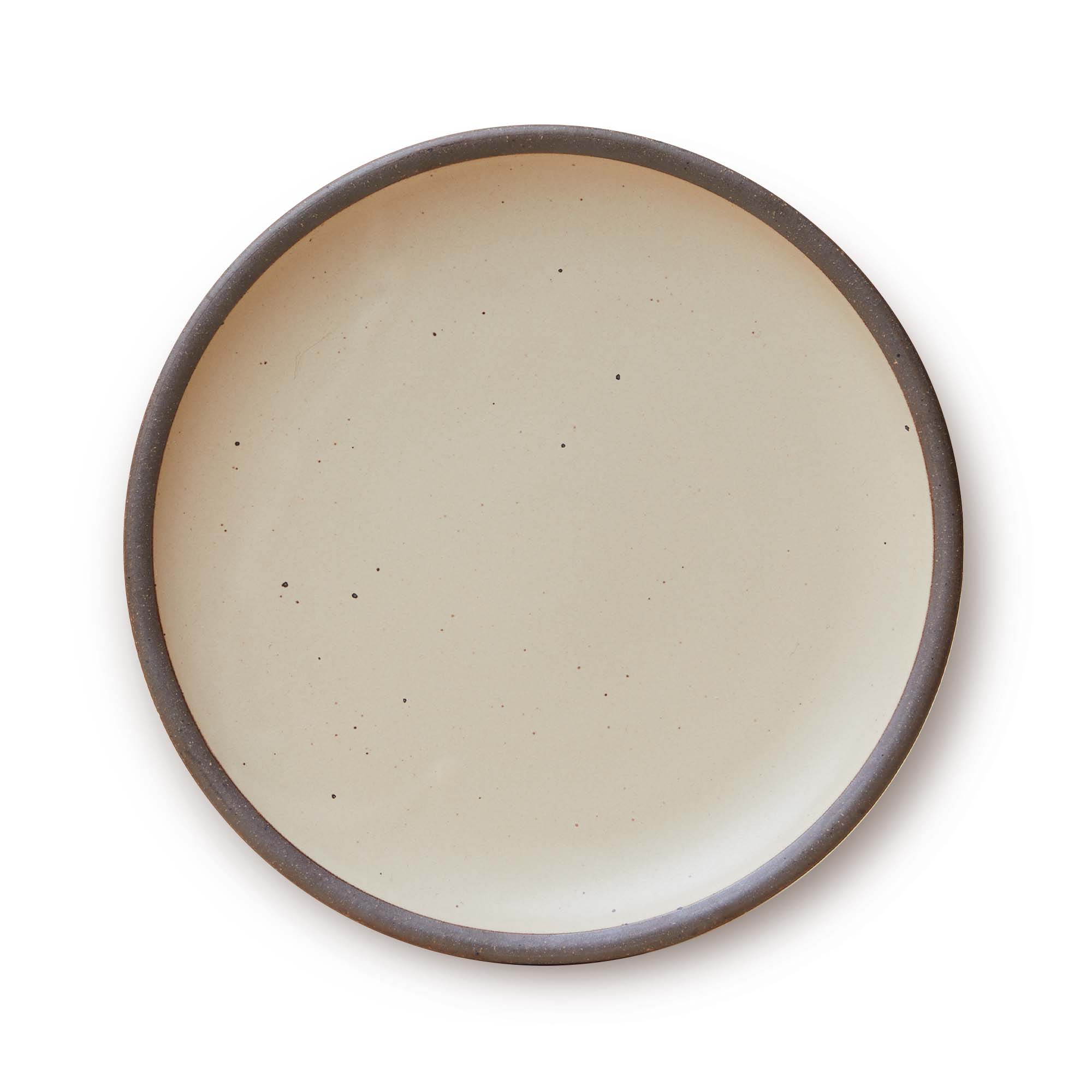 A large ceramic platter in a natural off-white color featuring iron speckles and an unglazed rim.