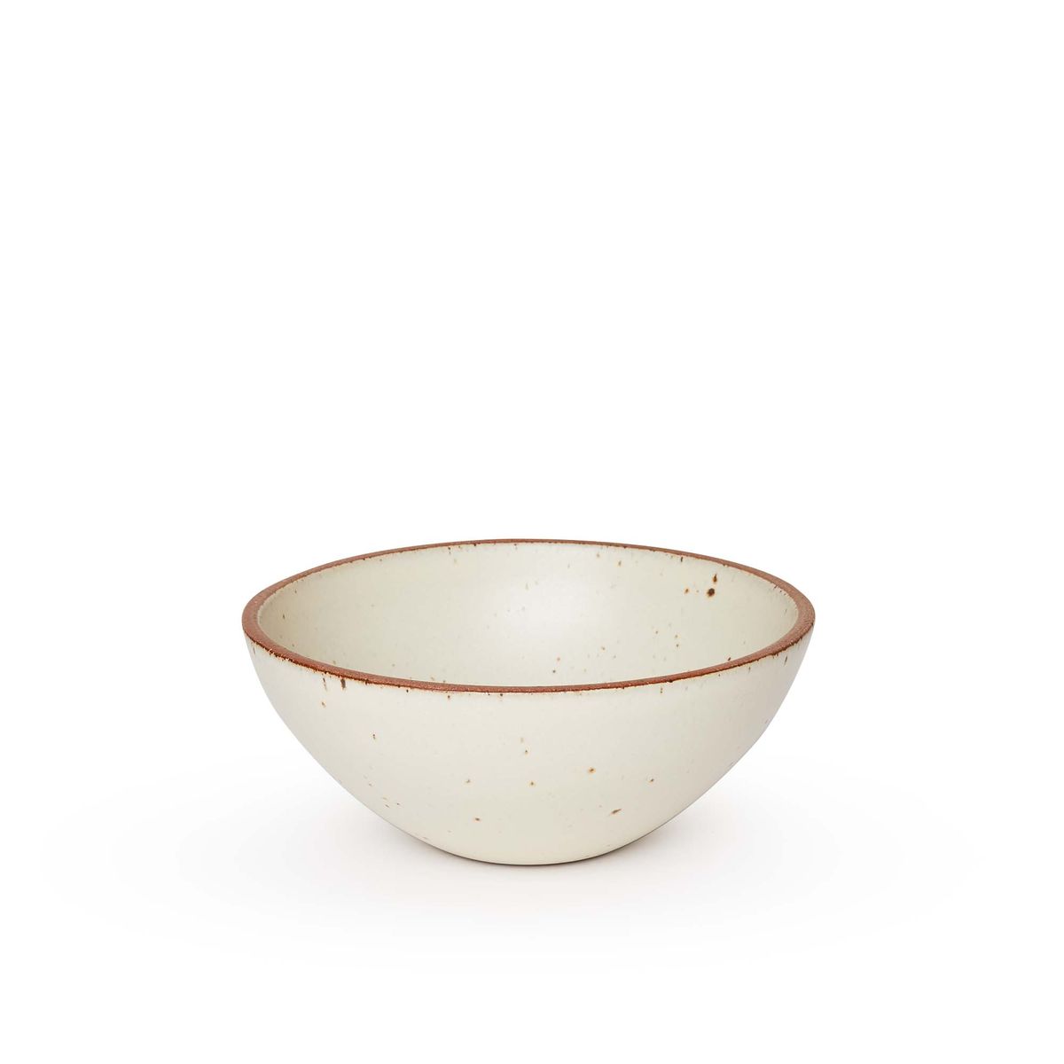 A medium rounded ceramic bowl in a warm, tan-toned, off-white color featuring iron speckles and an unglazed rim