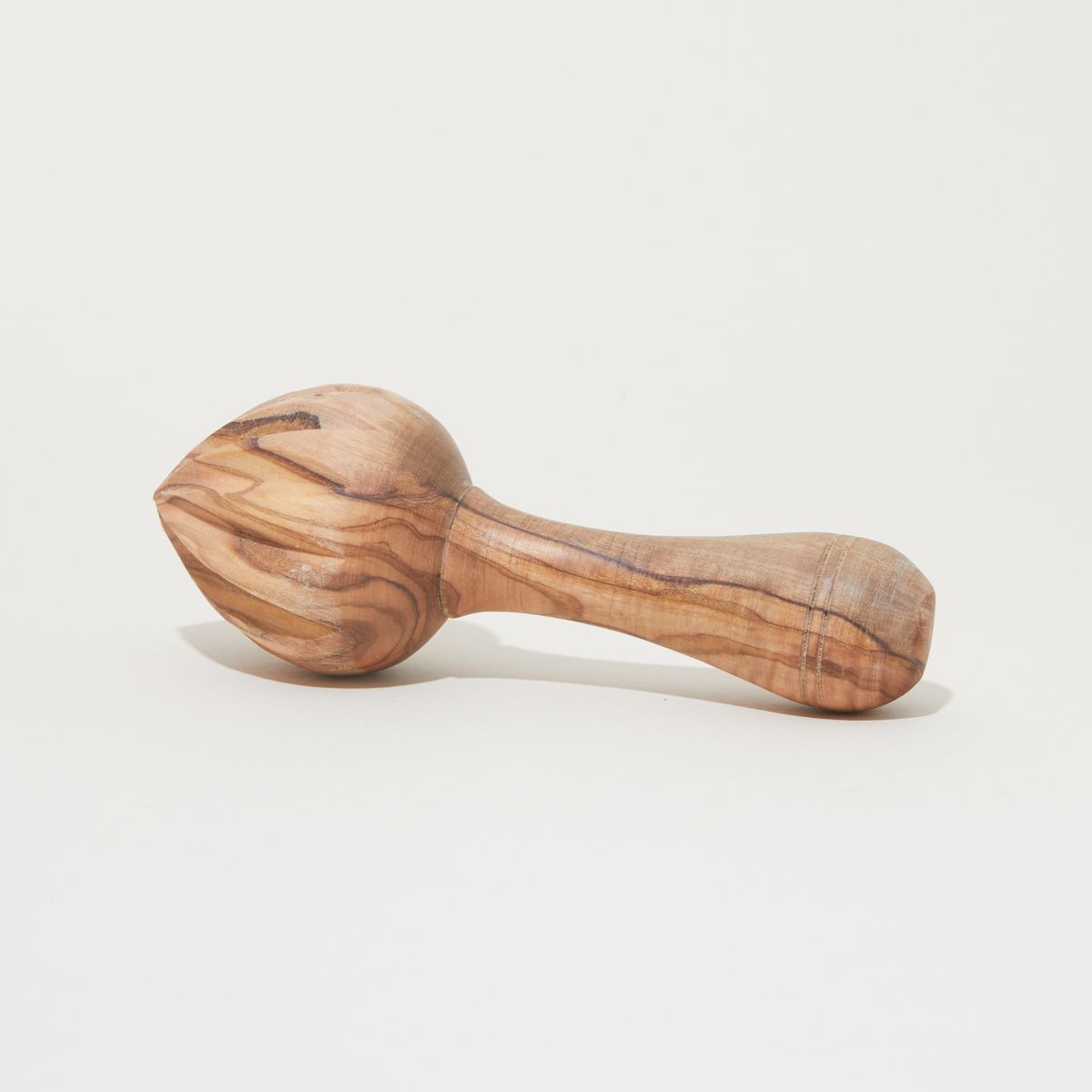 A citrus reamer made from marbled olivewood