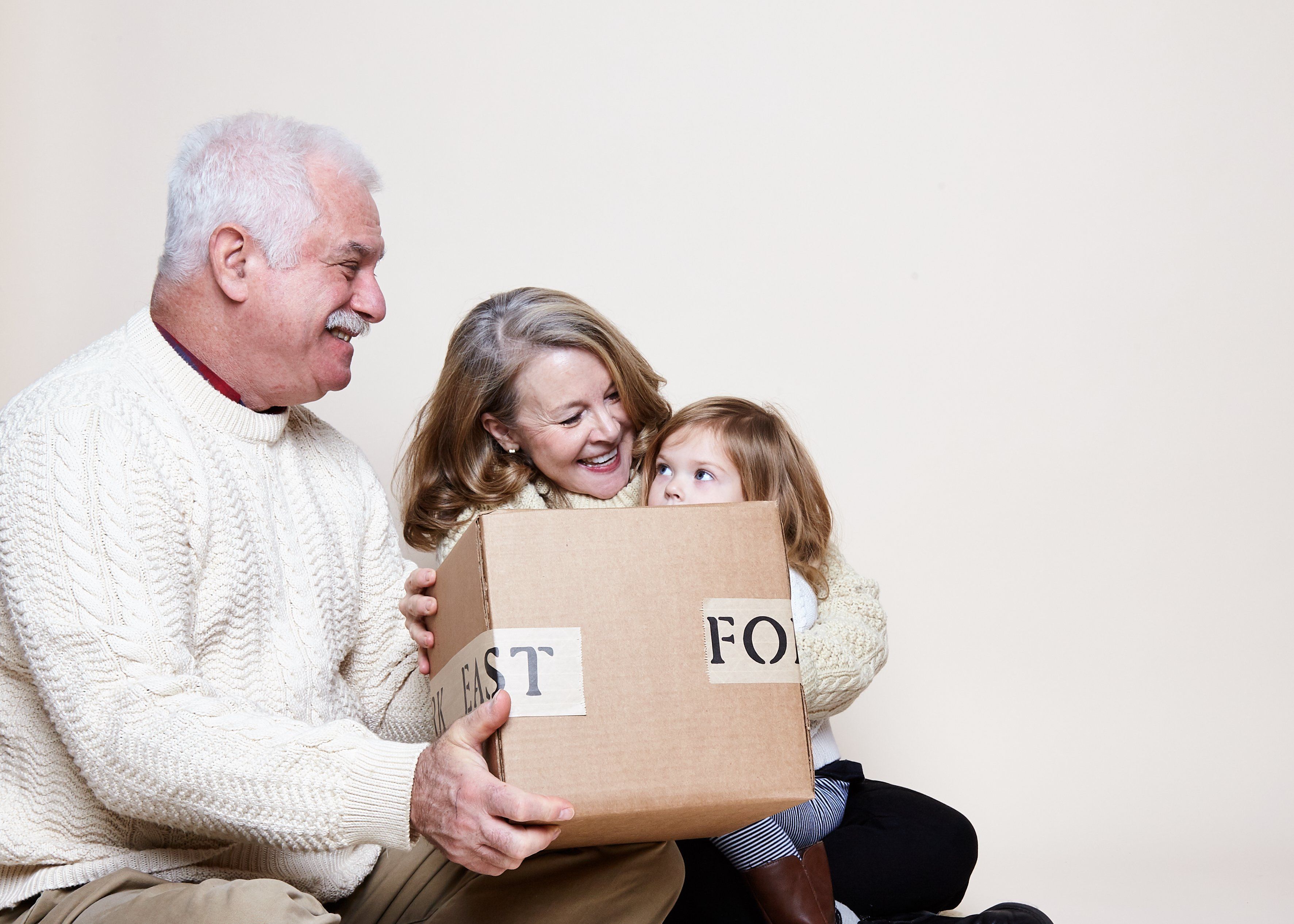 Grandparents and grandchild holding East Fork Pottery box