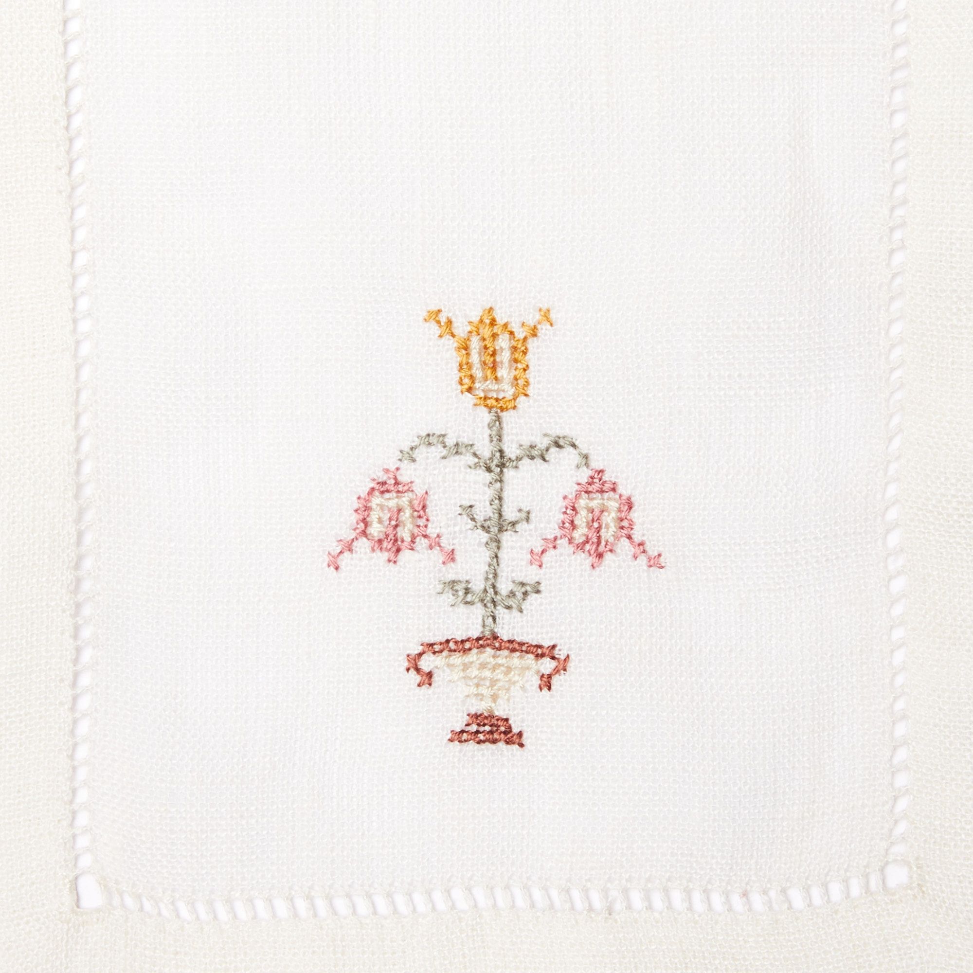 Close up of cloth rectangle napkin with embroidered flower