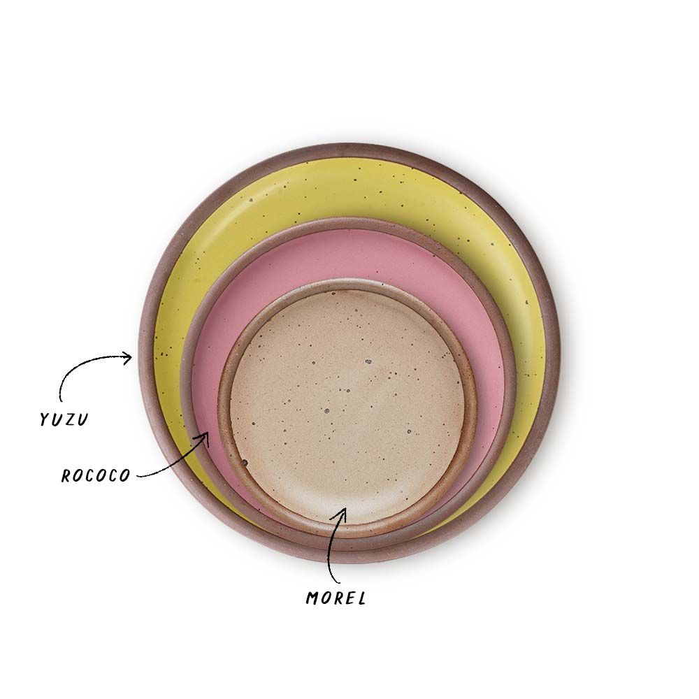 A stack of 3 plates in Dinner, Side, and Cake sizes in a zesty yellow, pink, and warm pale brown colors.