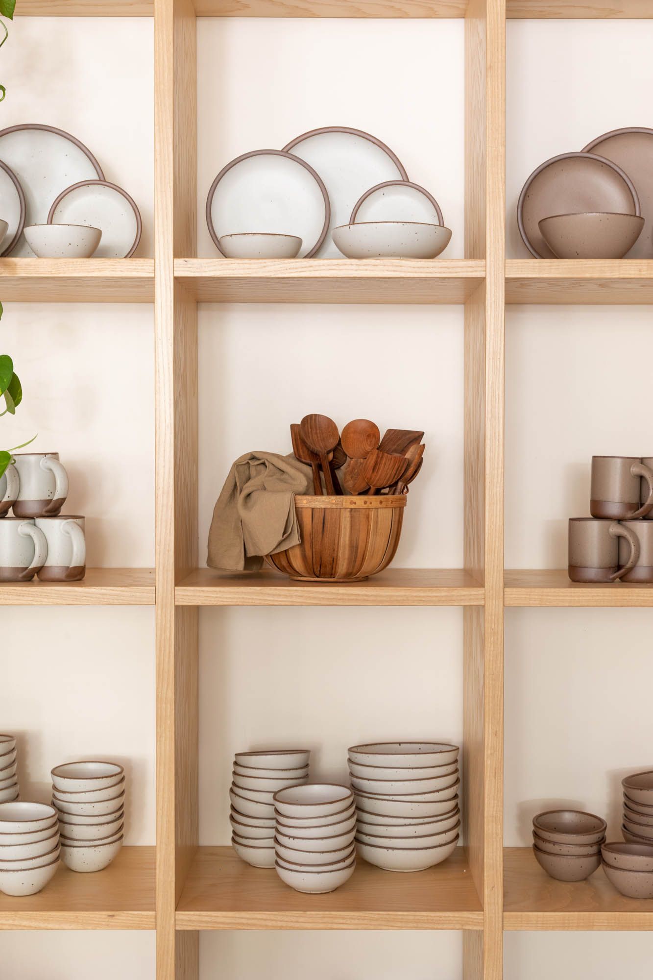 Wood shelves of ceramic pottery sets and kitchen accessories