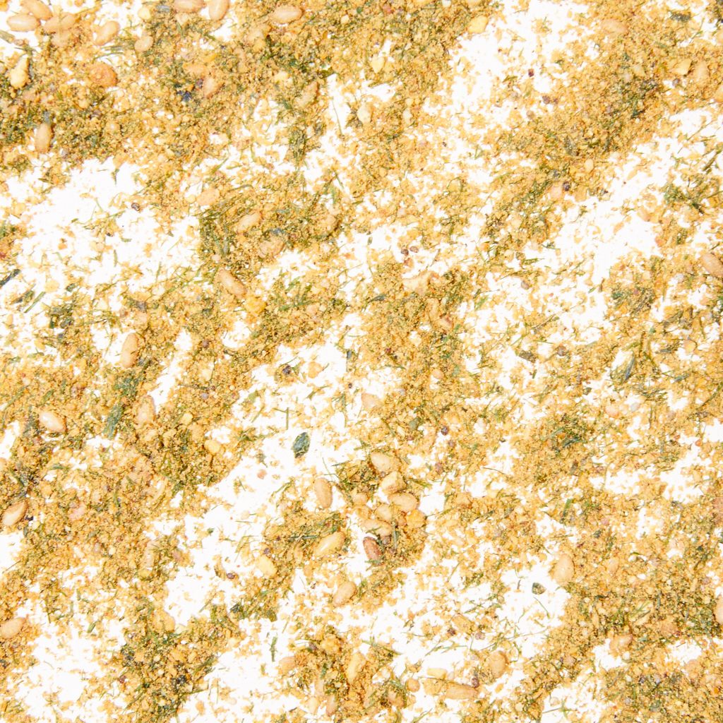 A close-up of togarashi, yellow, white and green grains