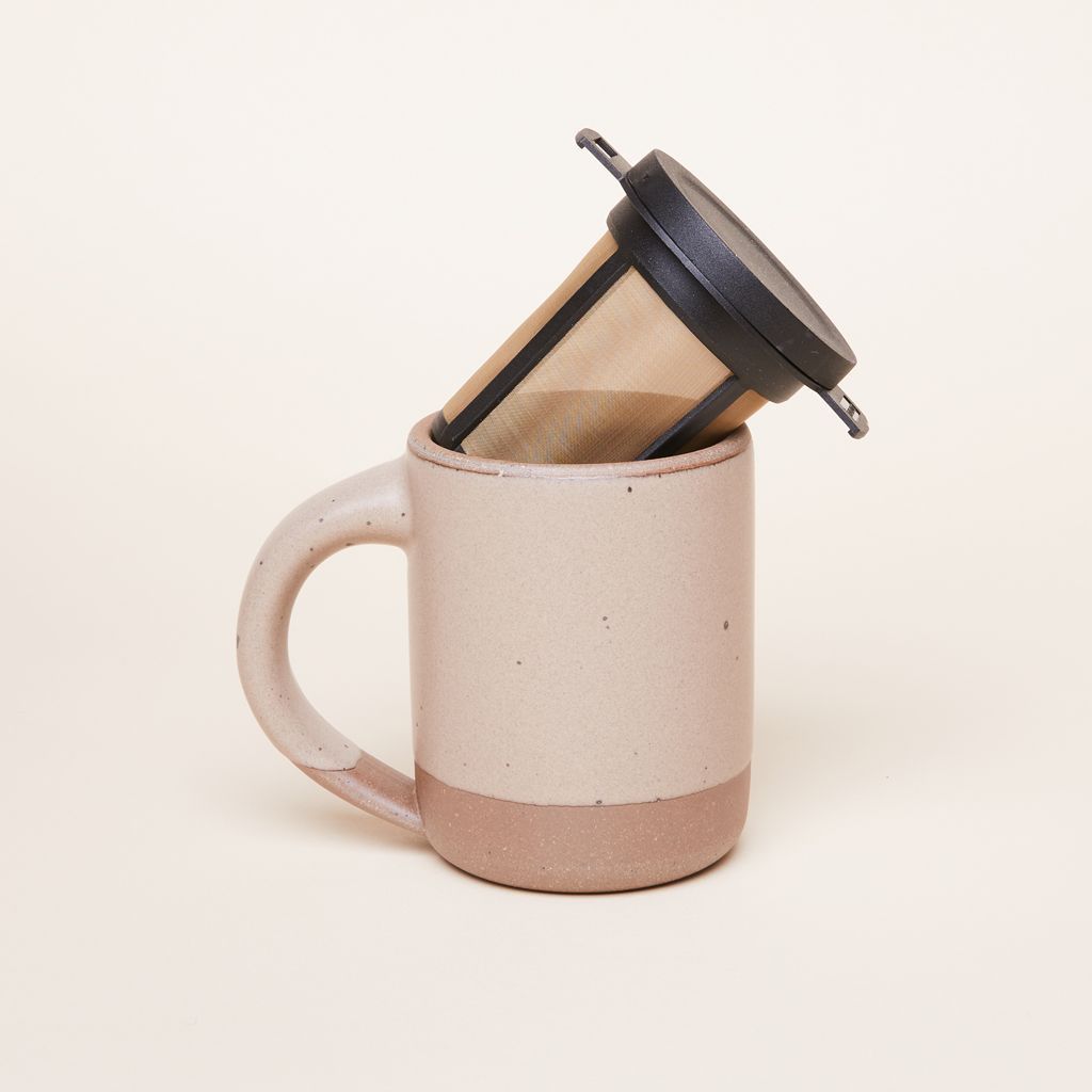 A brewing basket sitting diagonally in an East Fork Mug in Morel.