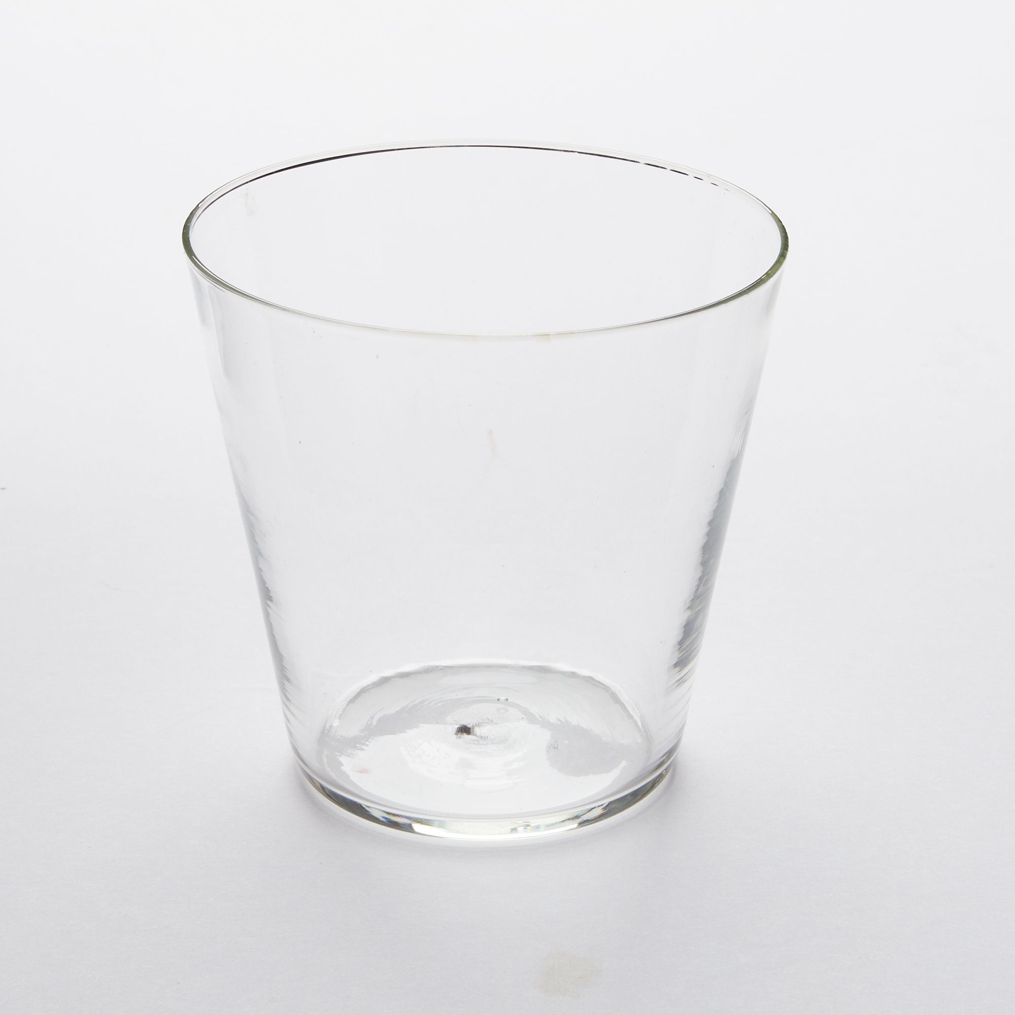A short drinking glass made of clear glass
