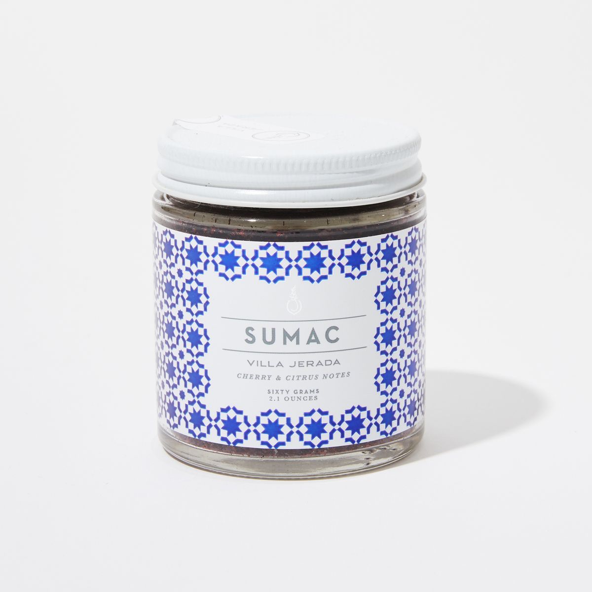 Jar with white lid and white label with geometric blue background and "Sumac" in grey sans-serif text