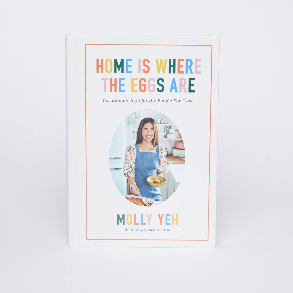 Cover of Home is Where the Eggs are. Image of Molly Yeh with the name of the book above in colorful letters.