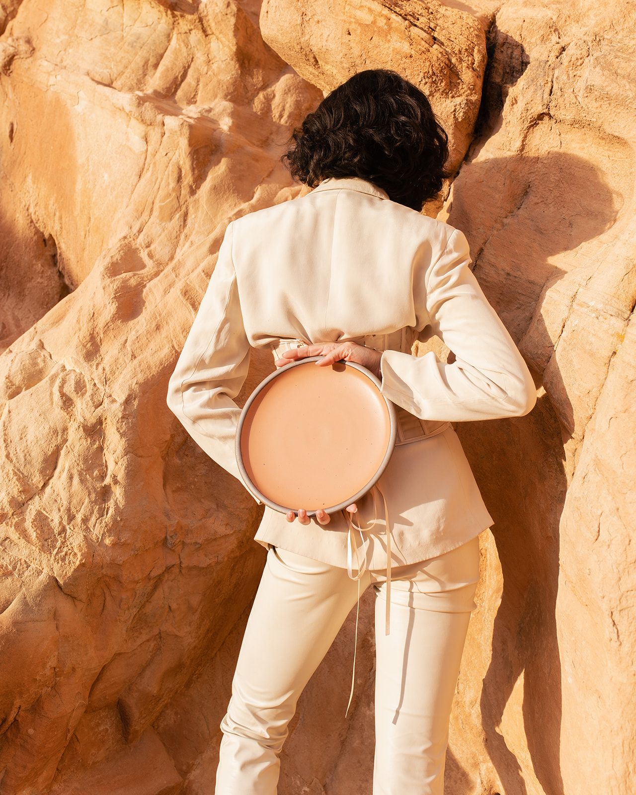 Maya Fraser photo of woman holding Utah dinner plate behind back