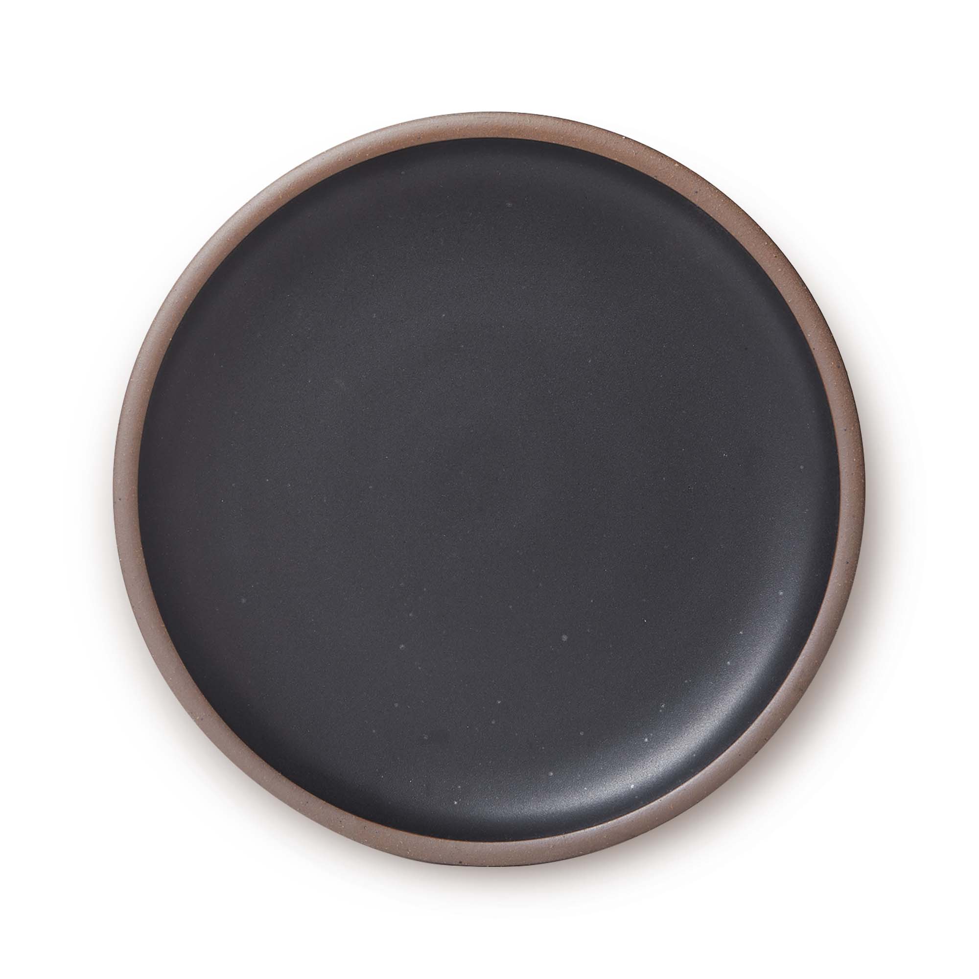 A large ceramic platter in a graphite black color featuring iron speckles and an unglazed rim.