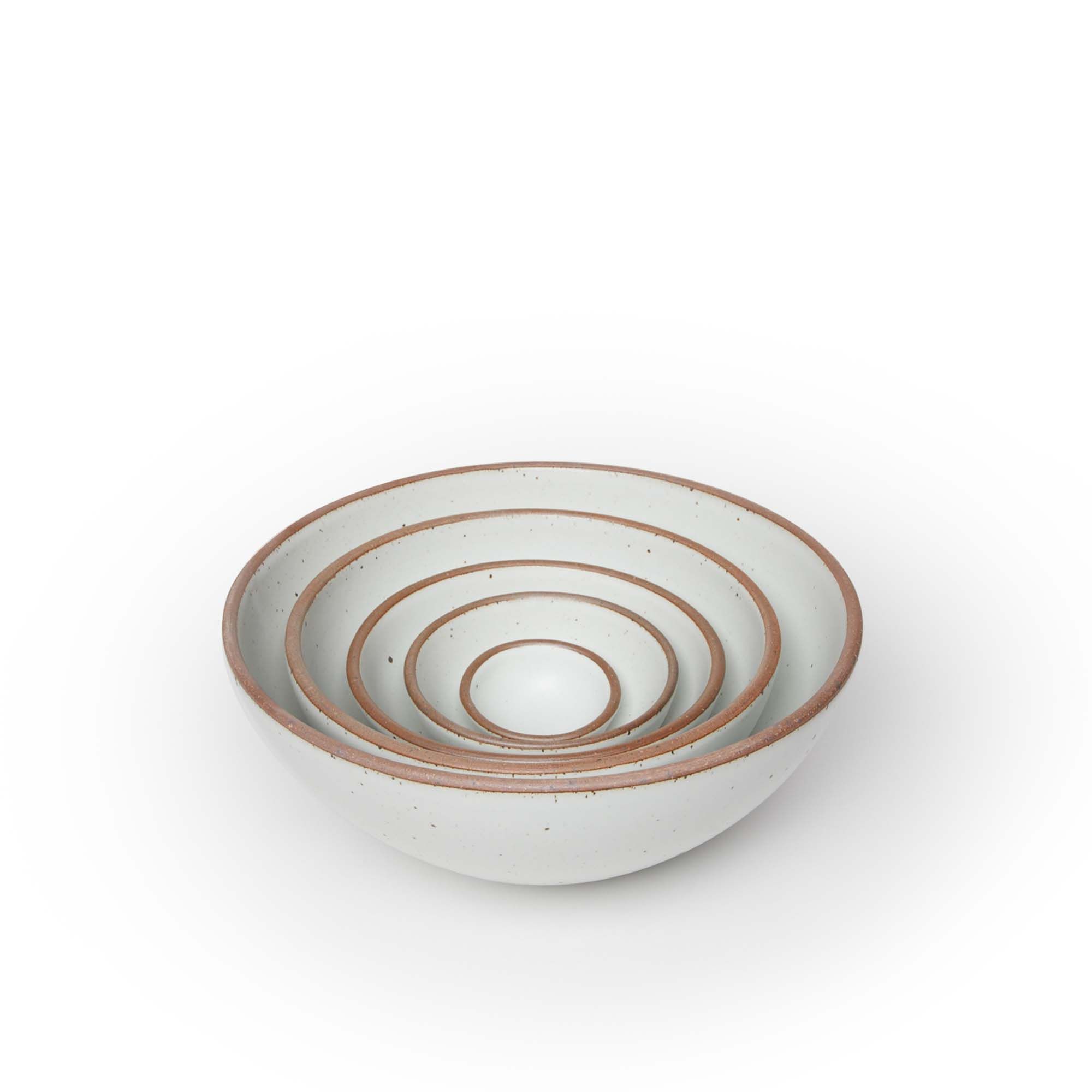 A bitty bowl, ice cream bowl, soup bowl, popcorn bowl, and mixing bowl nesting together in a cool white color featuring iron speckles.