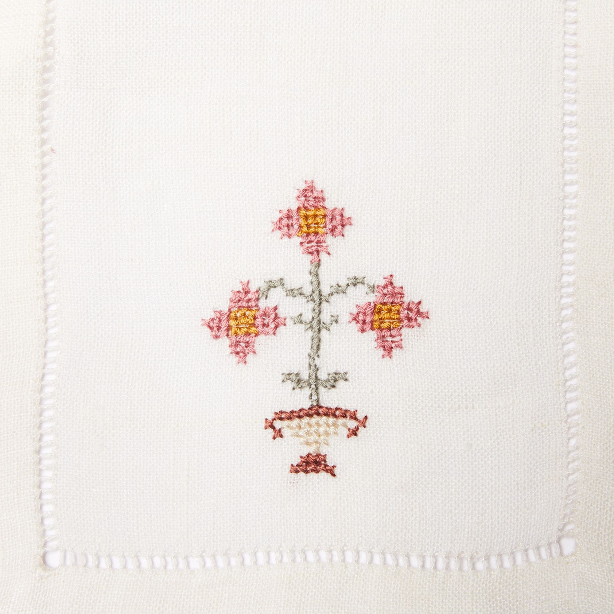 Close up of cloth rectangle napkin with embroidered flower