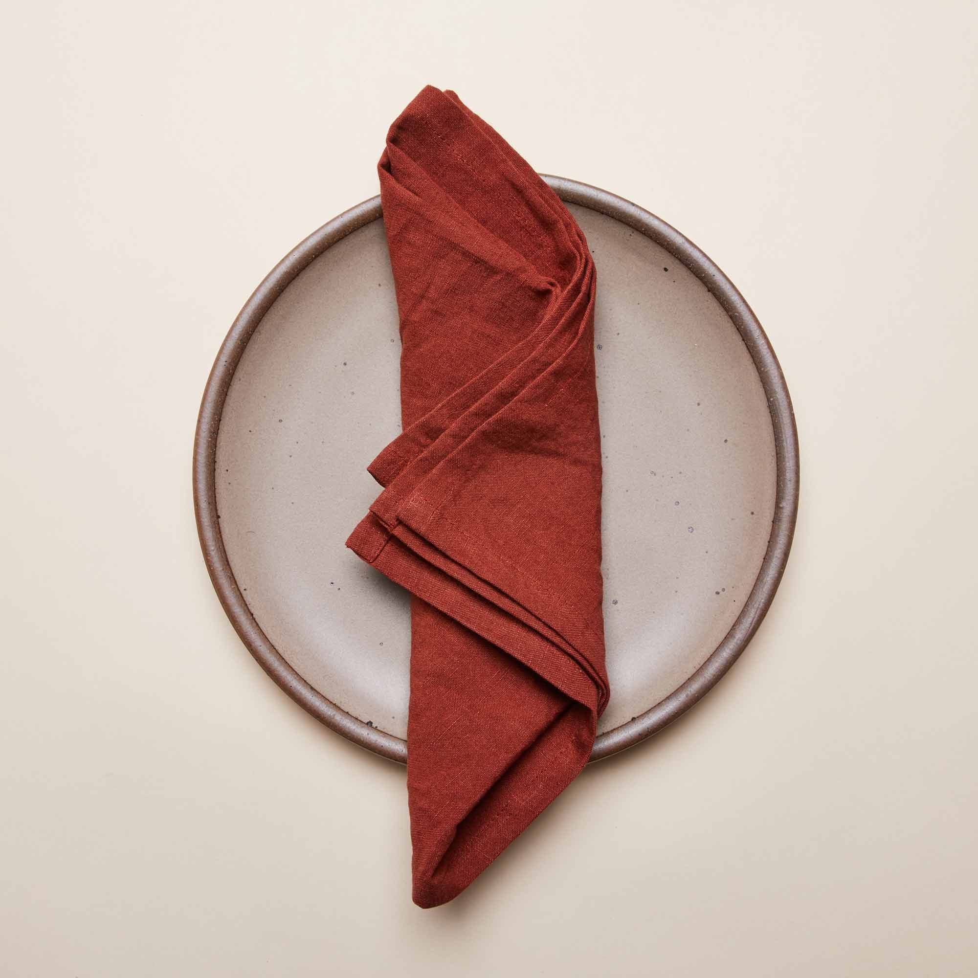 An Amaro napkin folded into quarters on an East Fork Dinner Plate in Morel