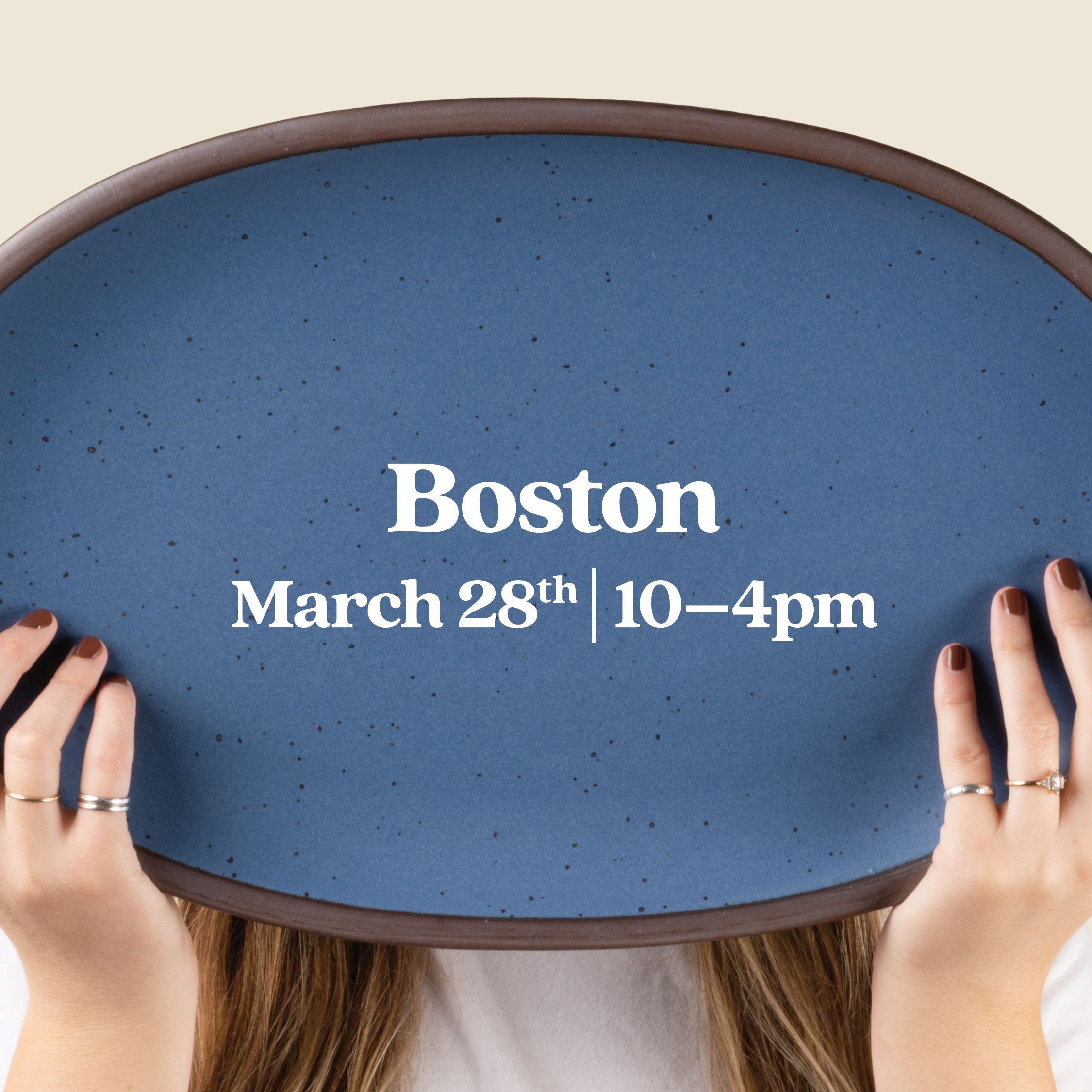Hands hold up a large oval platter in a grounded blue color with text overlay that reads 'Boston March 28th 10-4pm"