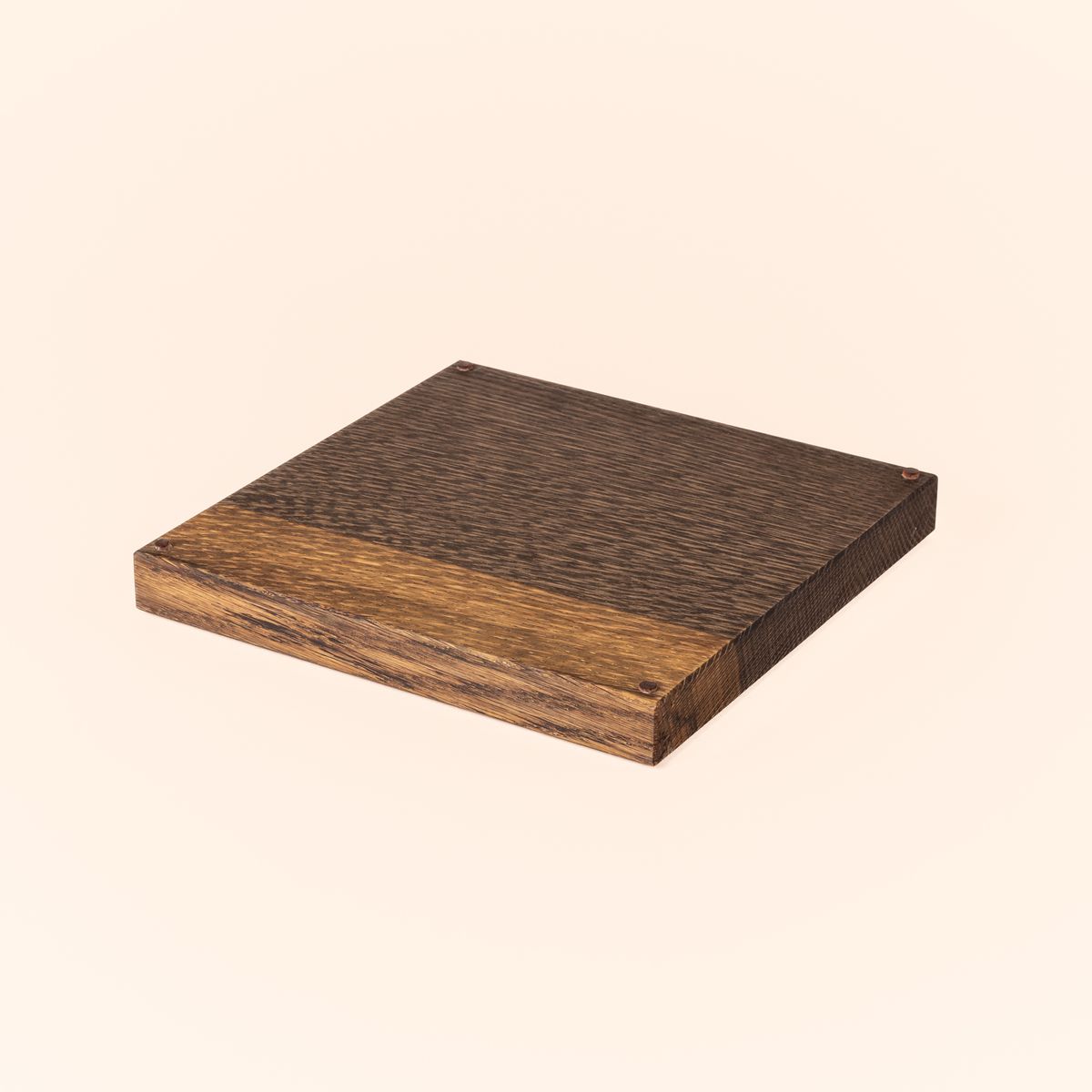 A square of white oak that has been finished in an ebonized stain