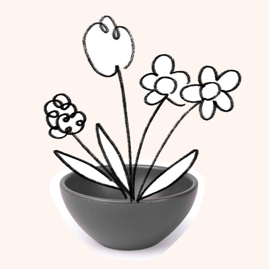 A small dessert-sized bowl with a black and white illustration of flowers coming out of it