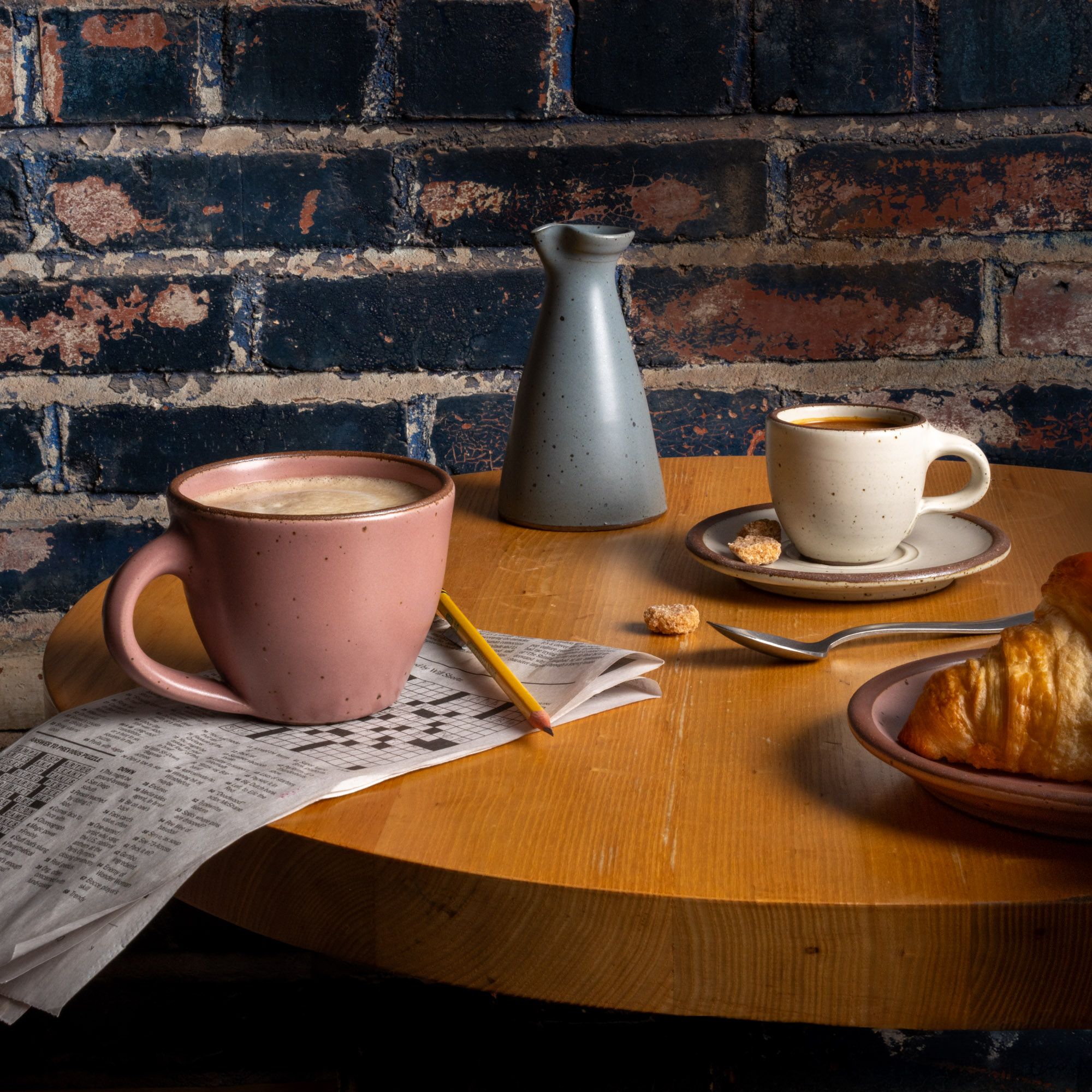 A table with East Fork Workshop pieces, The Sunday Morning Mug, The Creamer, the Espresso Cup and Saucer.