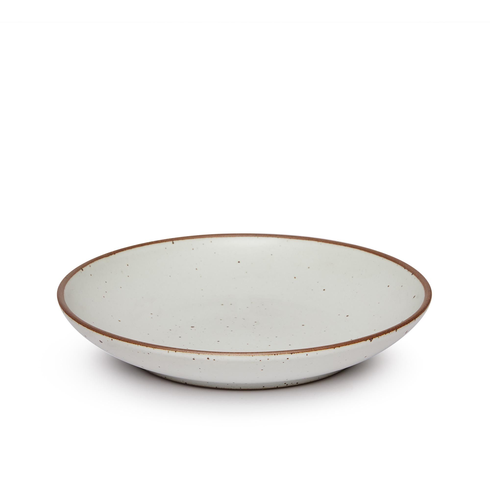A large ceramic plate with a curved bowl edge in a cool white color featuring iron speckles and an unglazed rim.