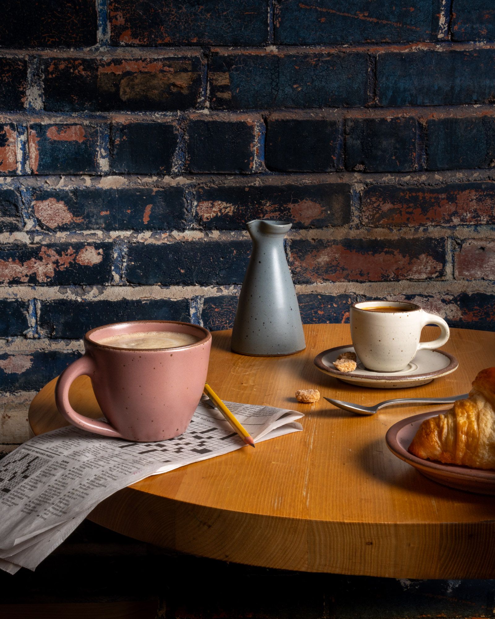 A table with East Fork Workshop pieces, The Sunday Morning Mug, The Creamer, the Espresso Cup and Saucer.