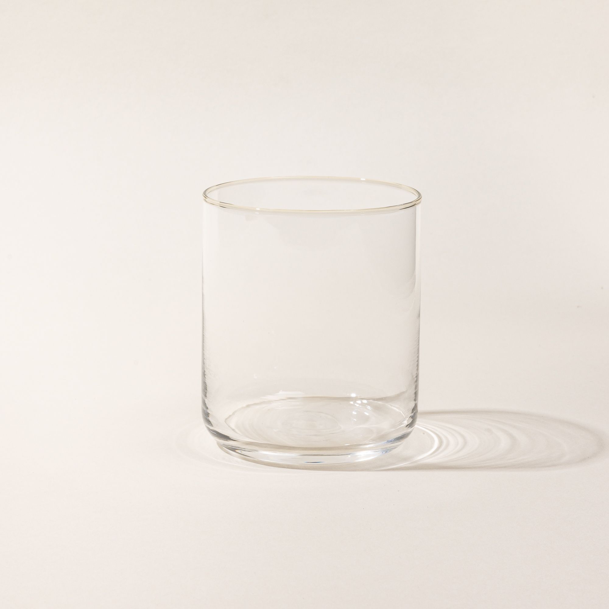 A straight walled short glass cup