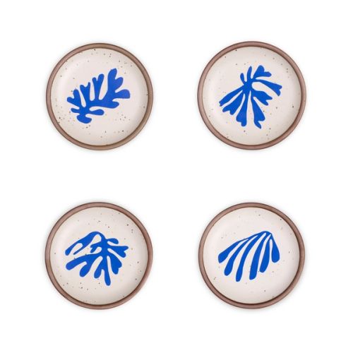 Four ceramic dessert sized plates in a warm off-white color with unglazed rim, with different frond-like cut-outs from Henri Matisse’s La Perruche et la sirène.