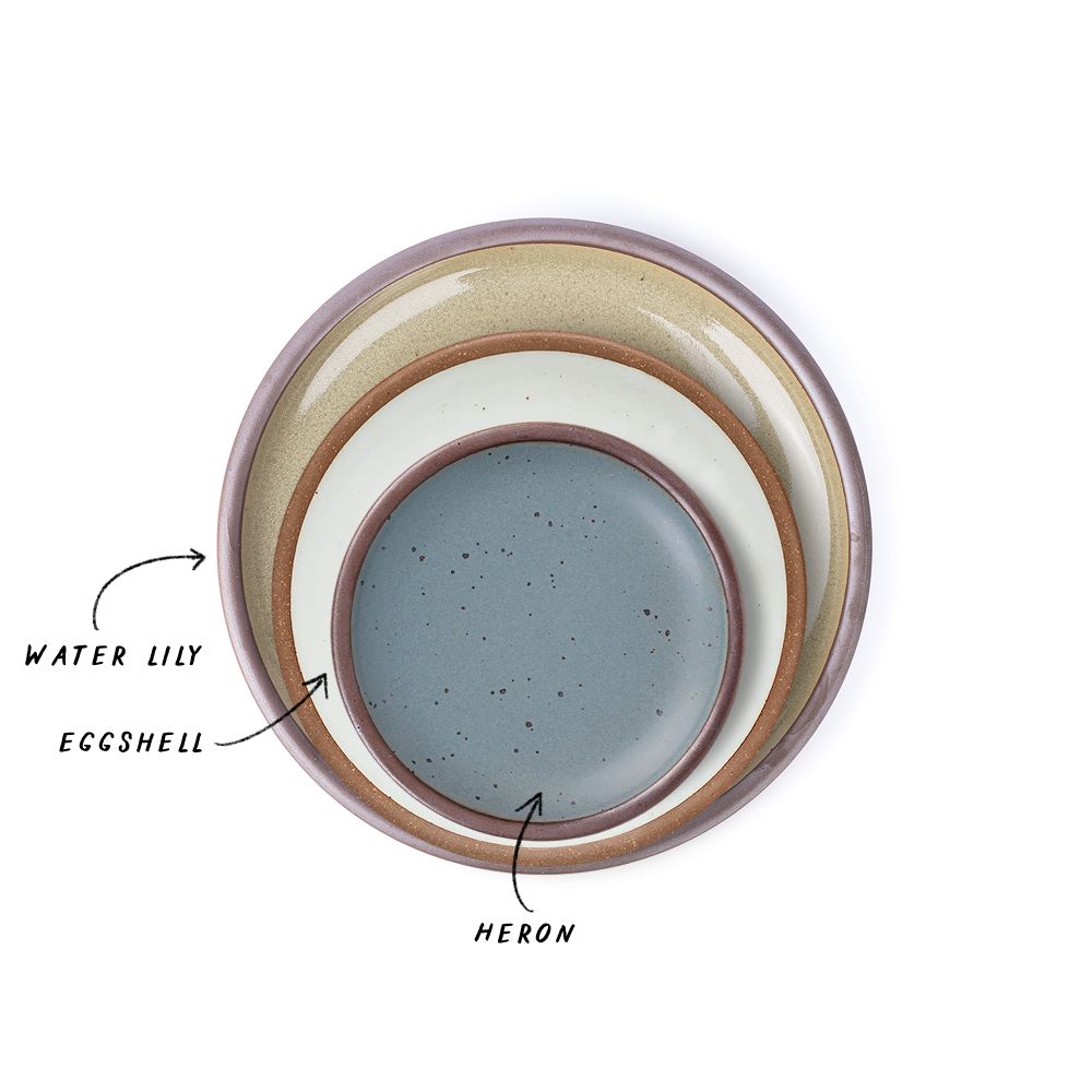 A stack of 3 plates in Dinner, Side, and Cake sizes in a reflective dappled grey-green, cool white, and blue-grey.