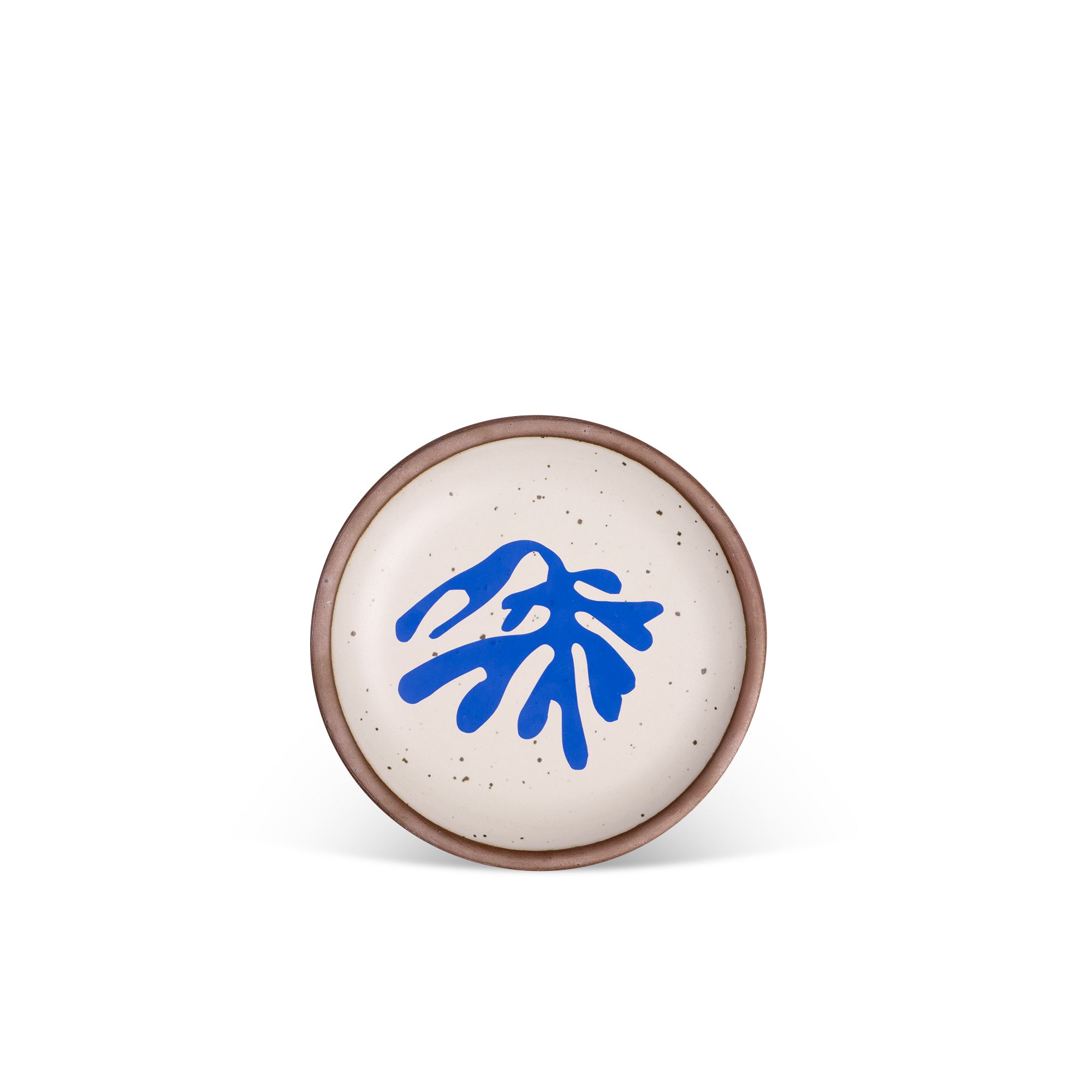 Abstract shape of a leaf in bright blue, centered on an off-white ceramic plate with an unglazed rim.