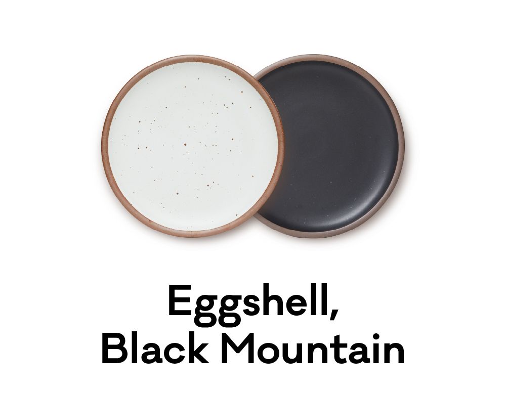 A white plate and a black plate are positioned next to each other. Underneath it reads "Eggshell, Black Mountain."