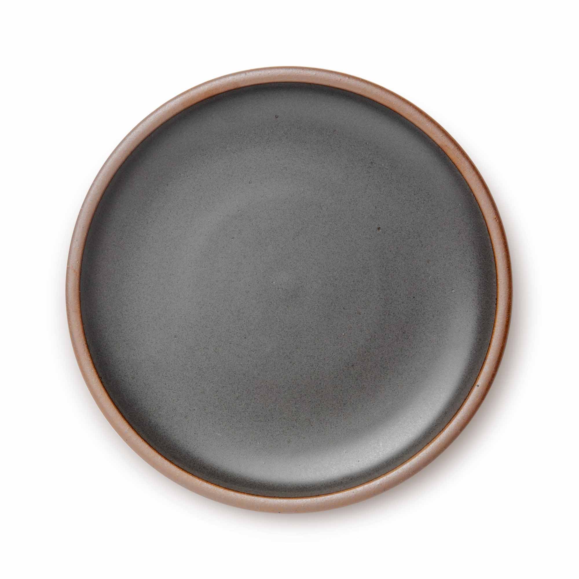 A large ceramic platter in a charcoal grey color featuring an unglazed rim.