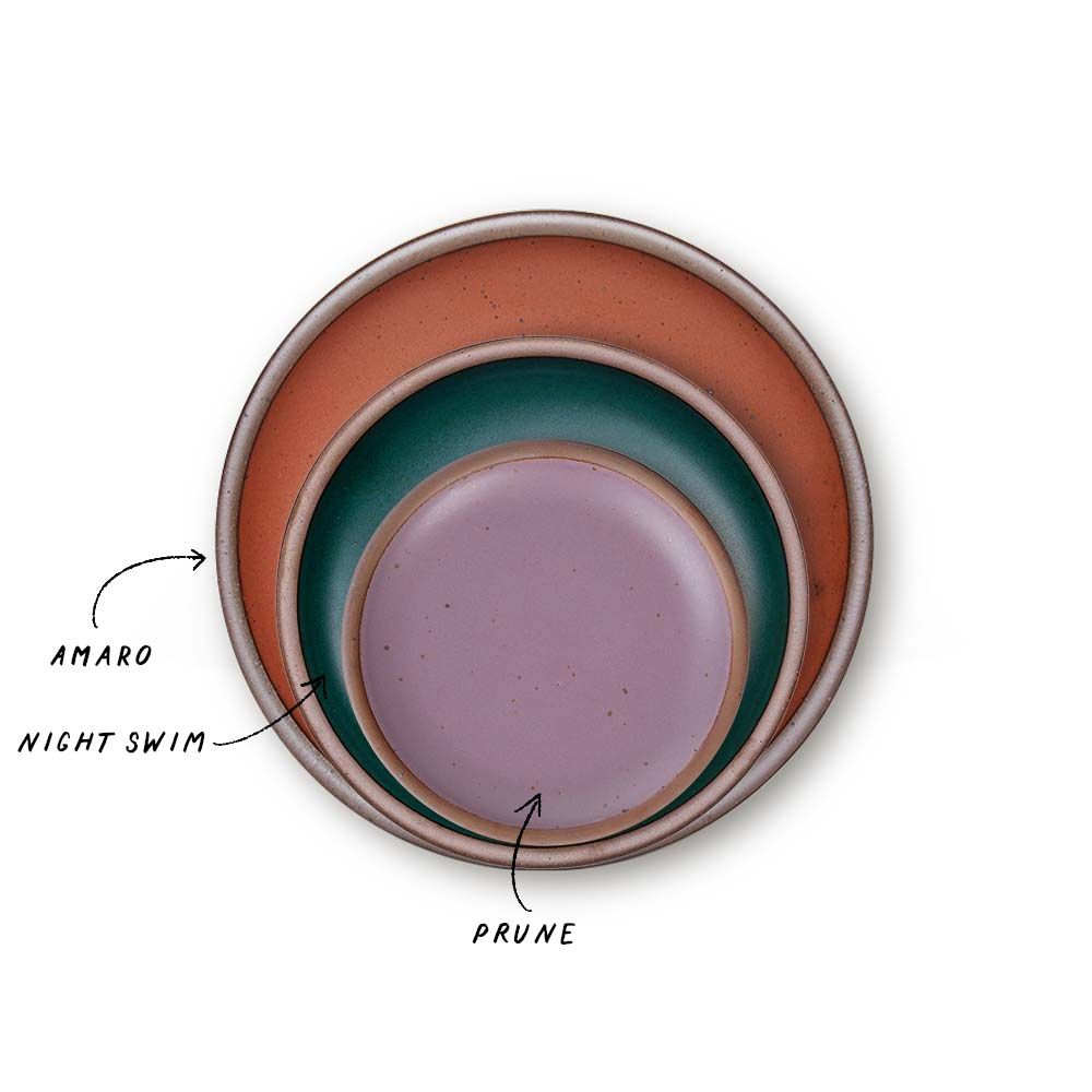 A stack of 3 plates in Dinner, Side, and Cake sizes in a cool terracotta, dark teal, and soft mauve purple colors.