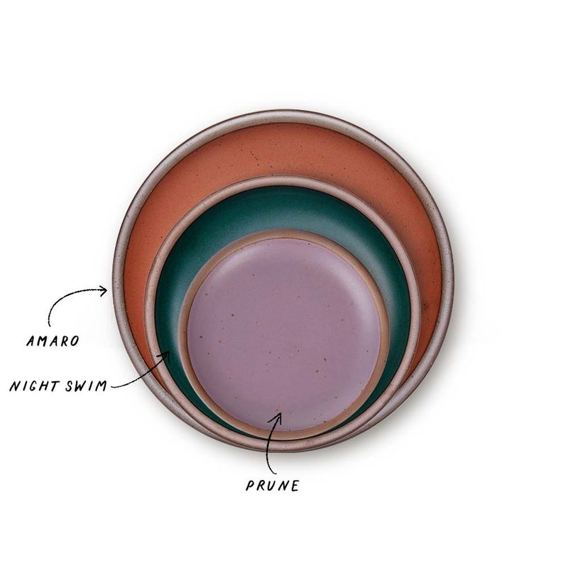 A stack of 3 plates in Dinner, Side, and Cake sizes in a cool terracotta, dark teal, and soft mauve purple colors.