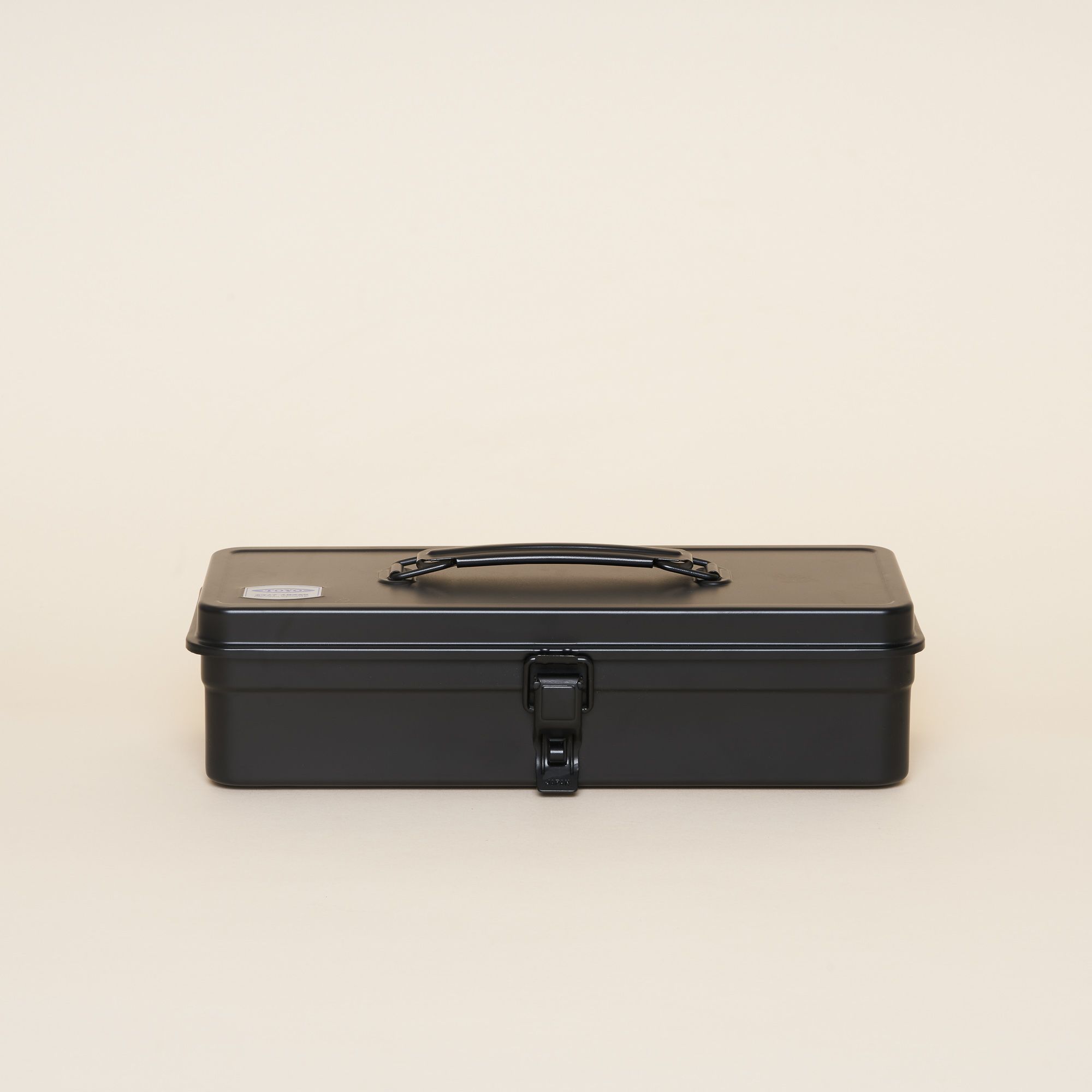 A black steel box with a handle and smooth round edges.