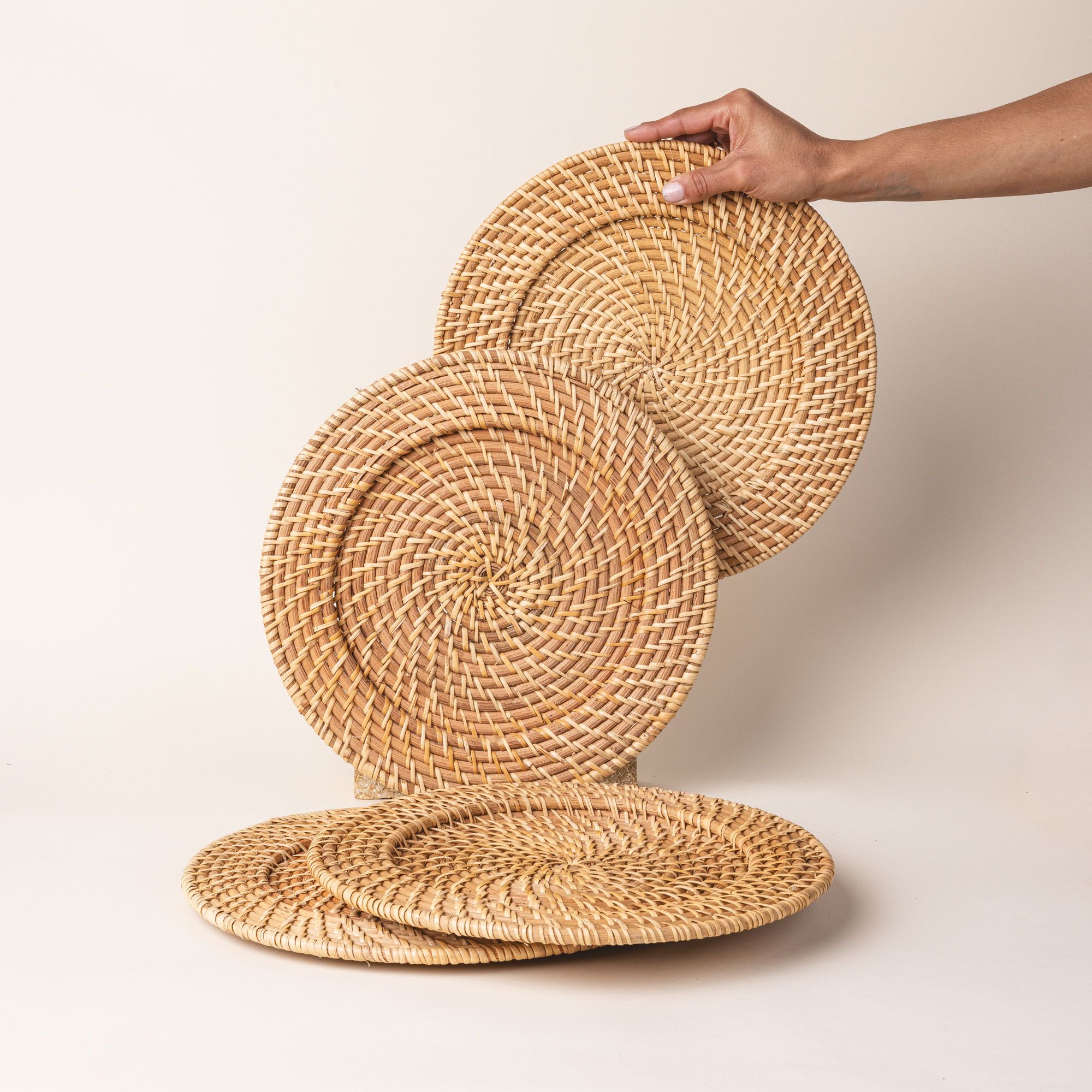 Four natural hand woven dinner plate chargers.