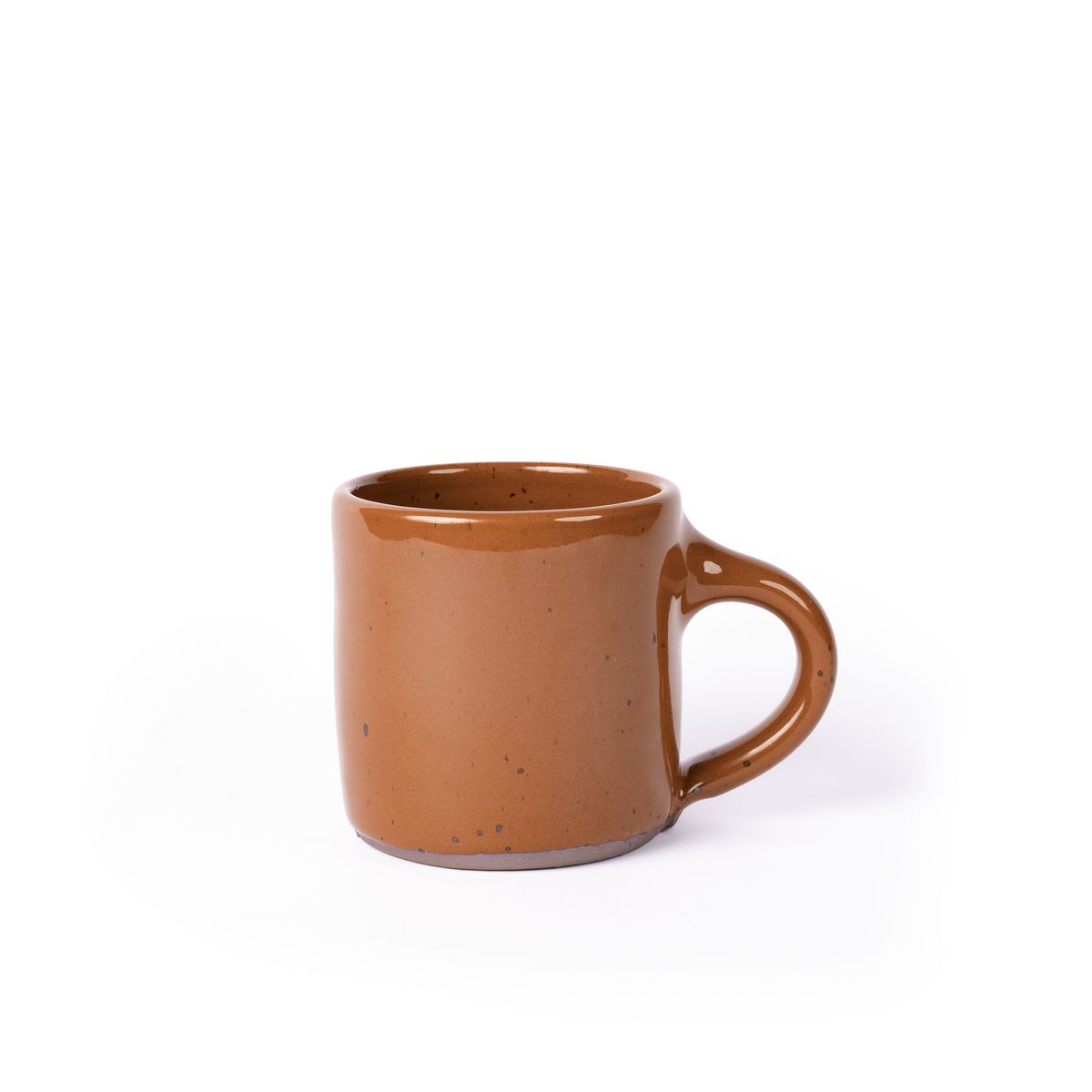 A medium sized ceramic mug with handle in a glossy caramel brown color featuring iron speckles