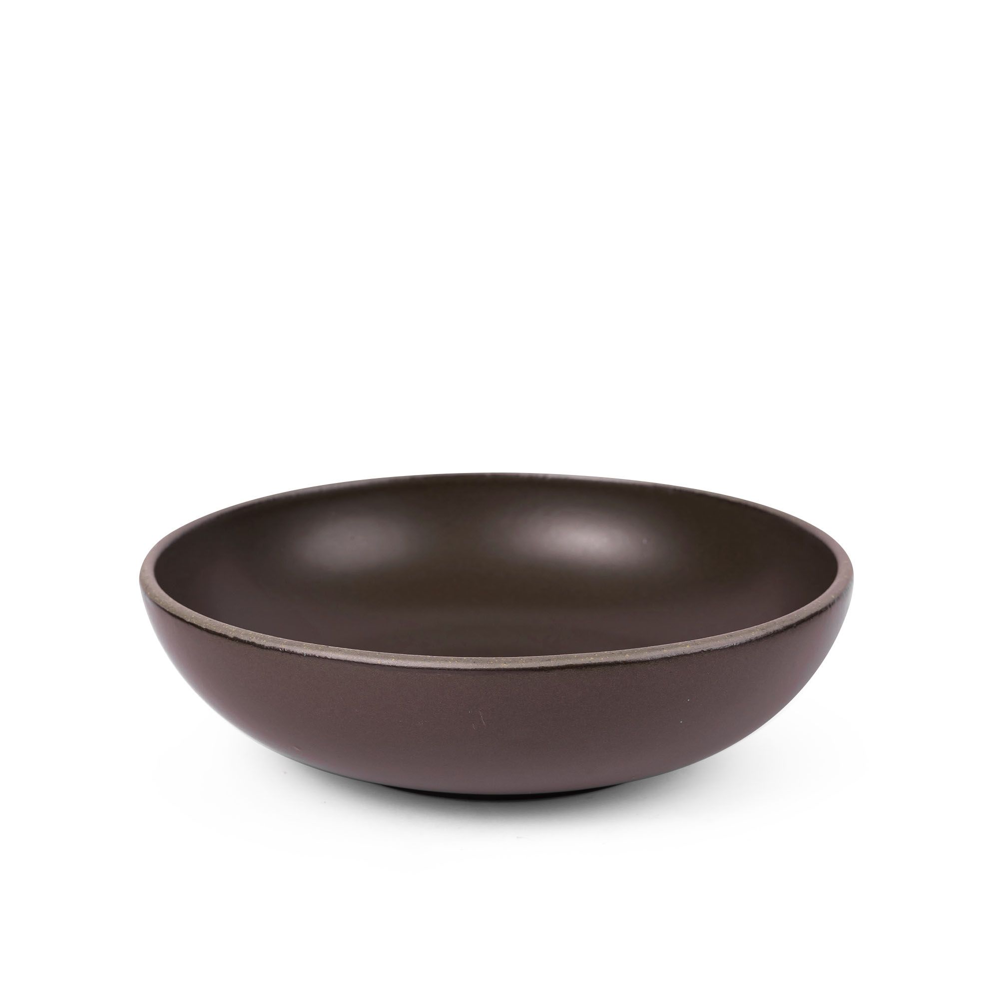 A large shallow serving ceramic bowl in a dark cool brown color featuring iron speckles and an unglazed rim.
