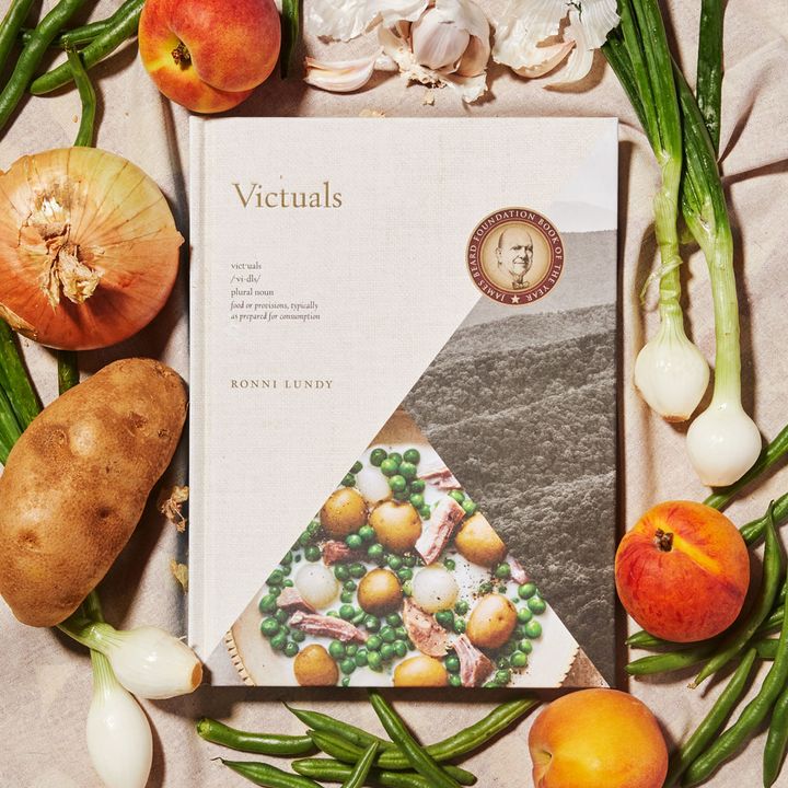Vituals Cookbook surrounded by green beans, green onions, onions, potatoes, and peaches