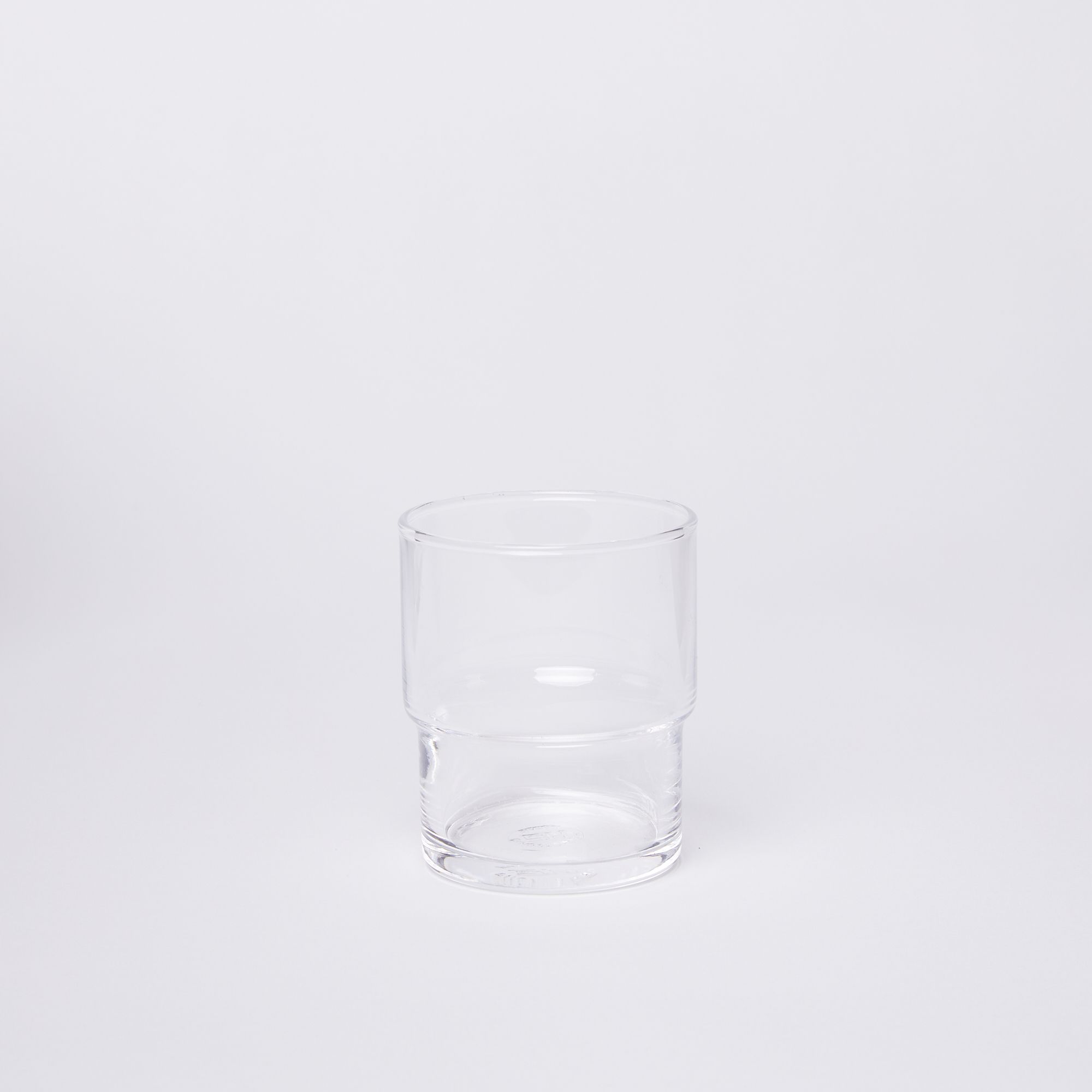 Clear cylindrical glass with a wider top half with a narrower bottom half