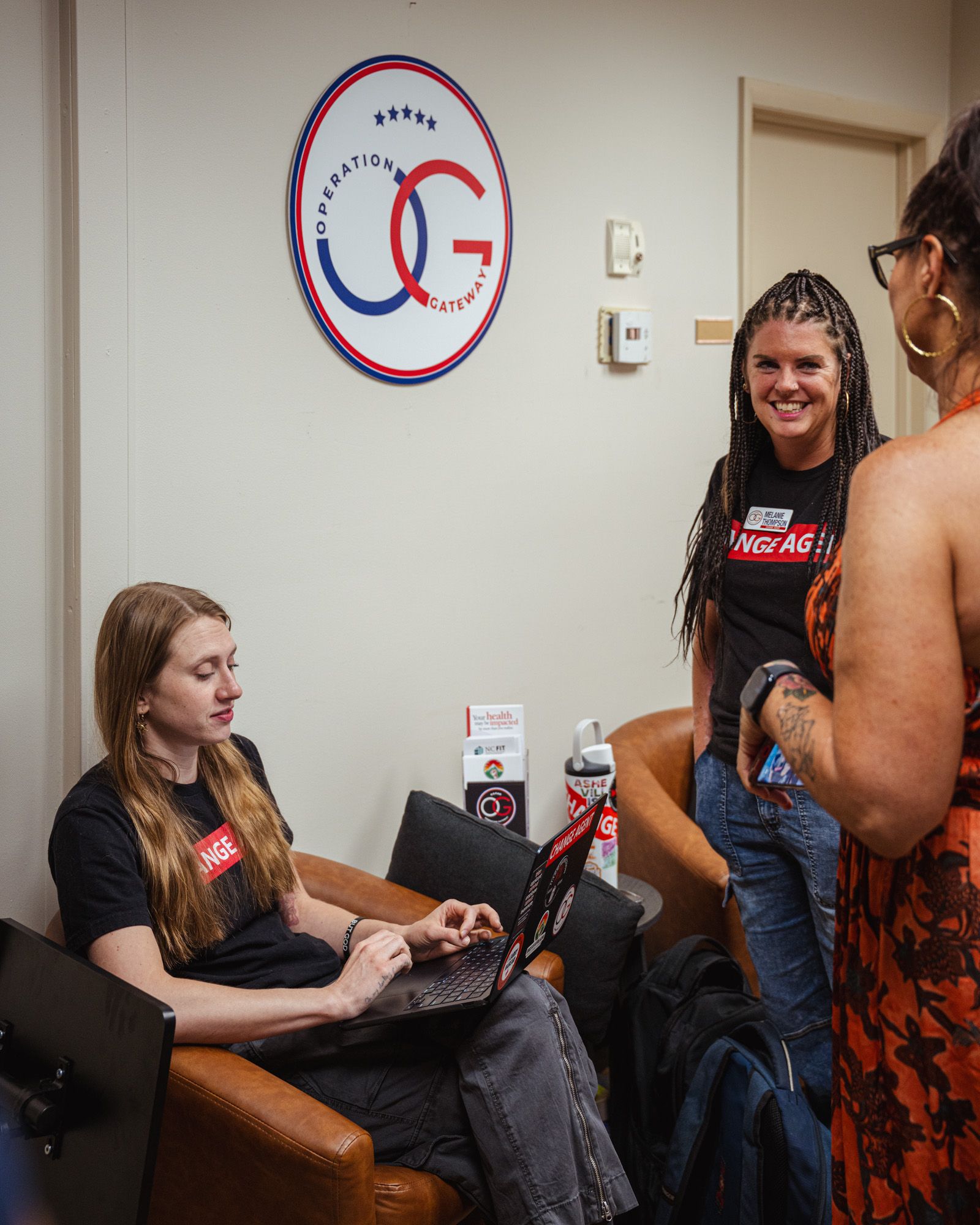 People are smiling and talking at Operation Gateway's office.