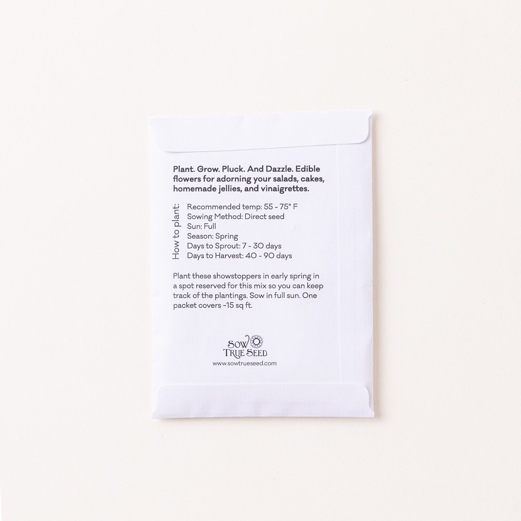 The back of a flat white seed pack filled with text instructions and info.