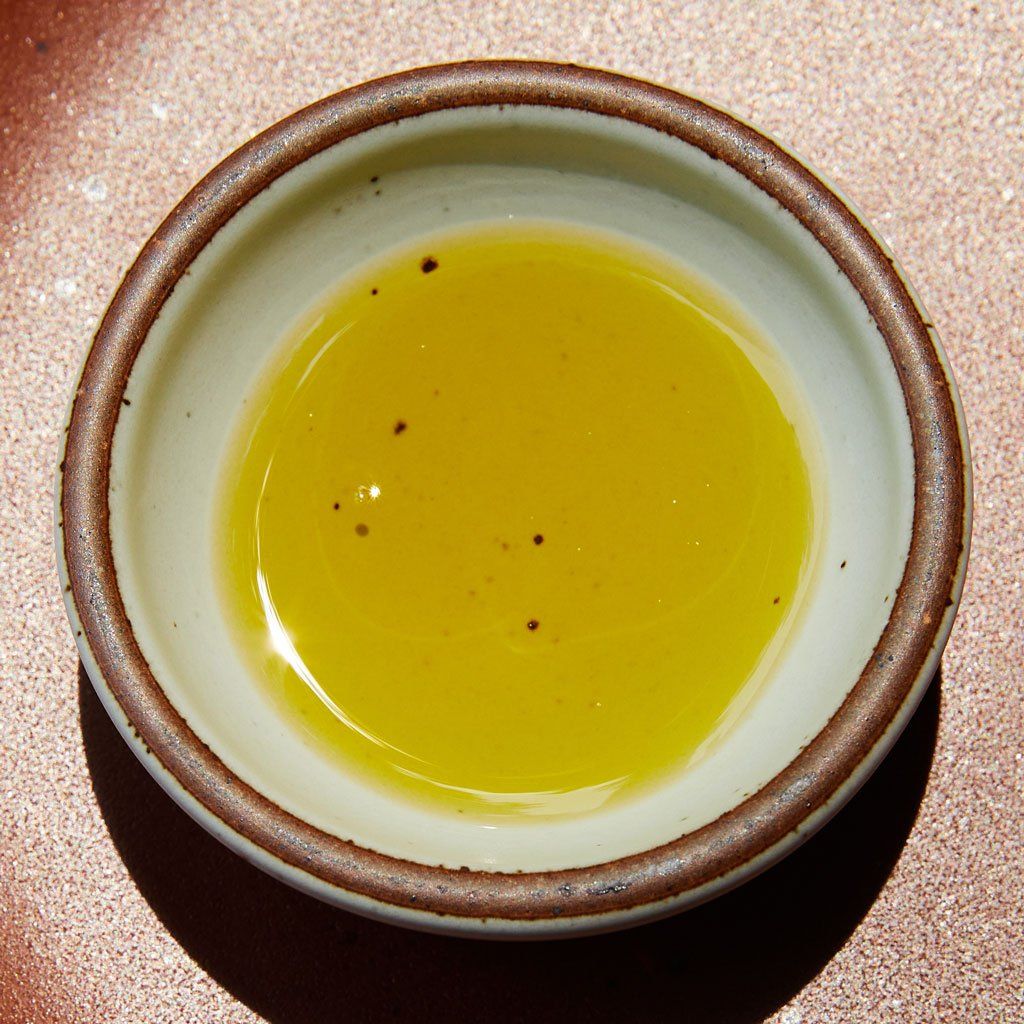 A pool of golden olive oil in an East Fork Bitty Bowl in Eggshell